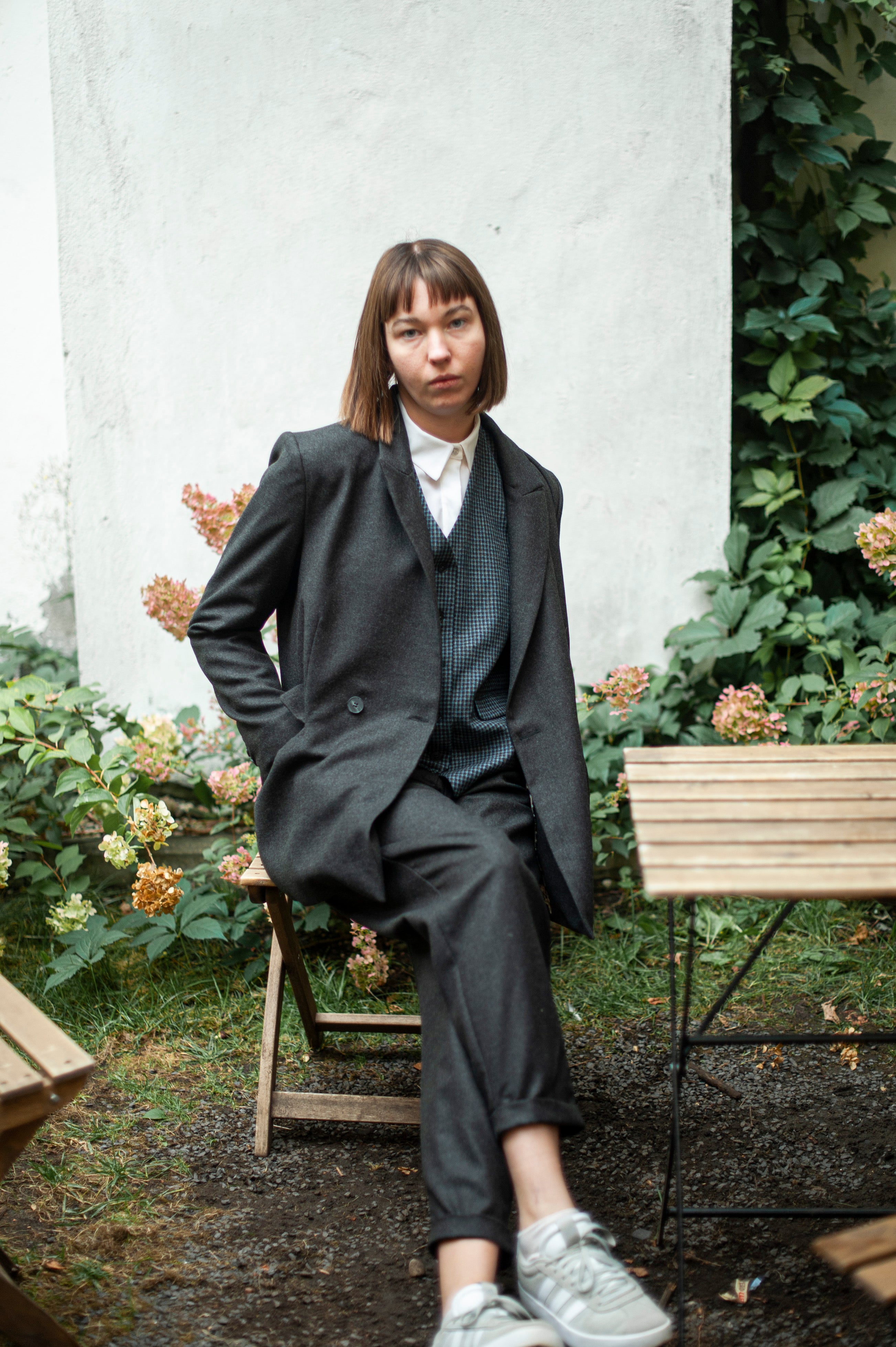 Grey premium quality wool suit featuring a double-breasted blazer and tapered-leg trousers. The ensemble is complemented by a relaxed-fitting blue check vest