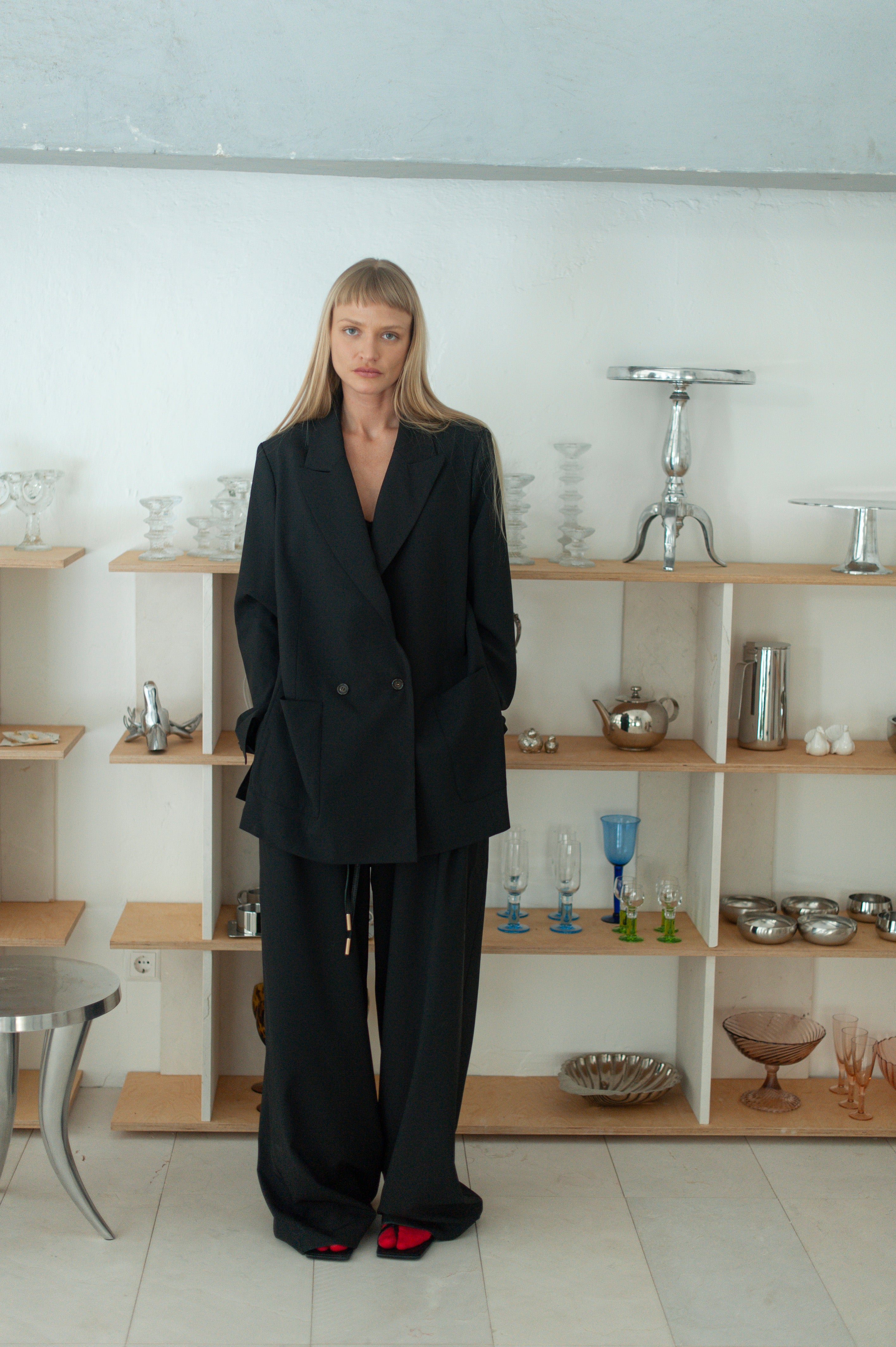 Minimalist wool pants with relaxed fit, worn with matching blazer