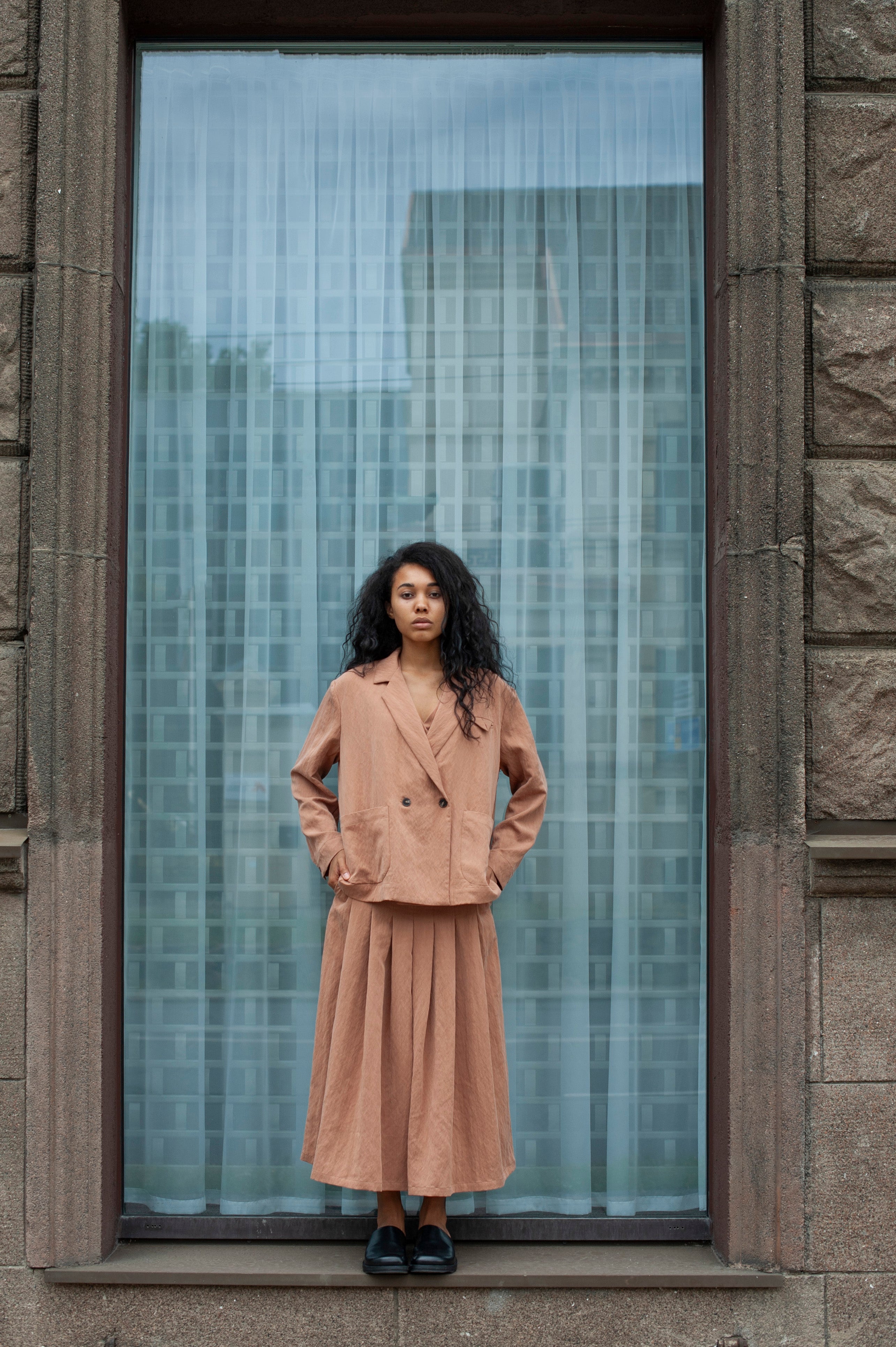 Women's linen two-piece co-ord set of wide-leg pleated pants and a boxy blazer boasting a double-breasted closure and patch pockets. Light beige