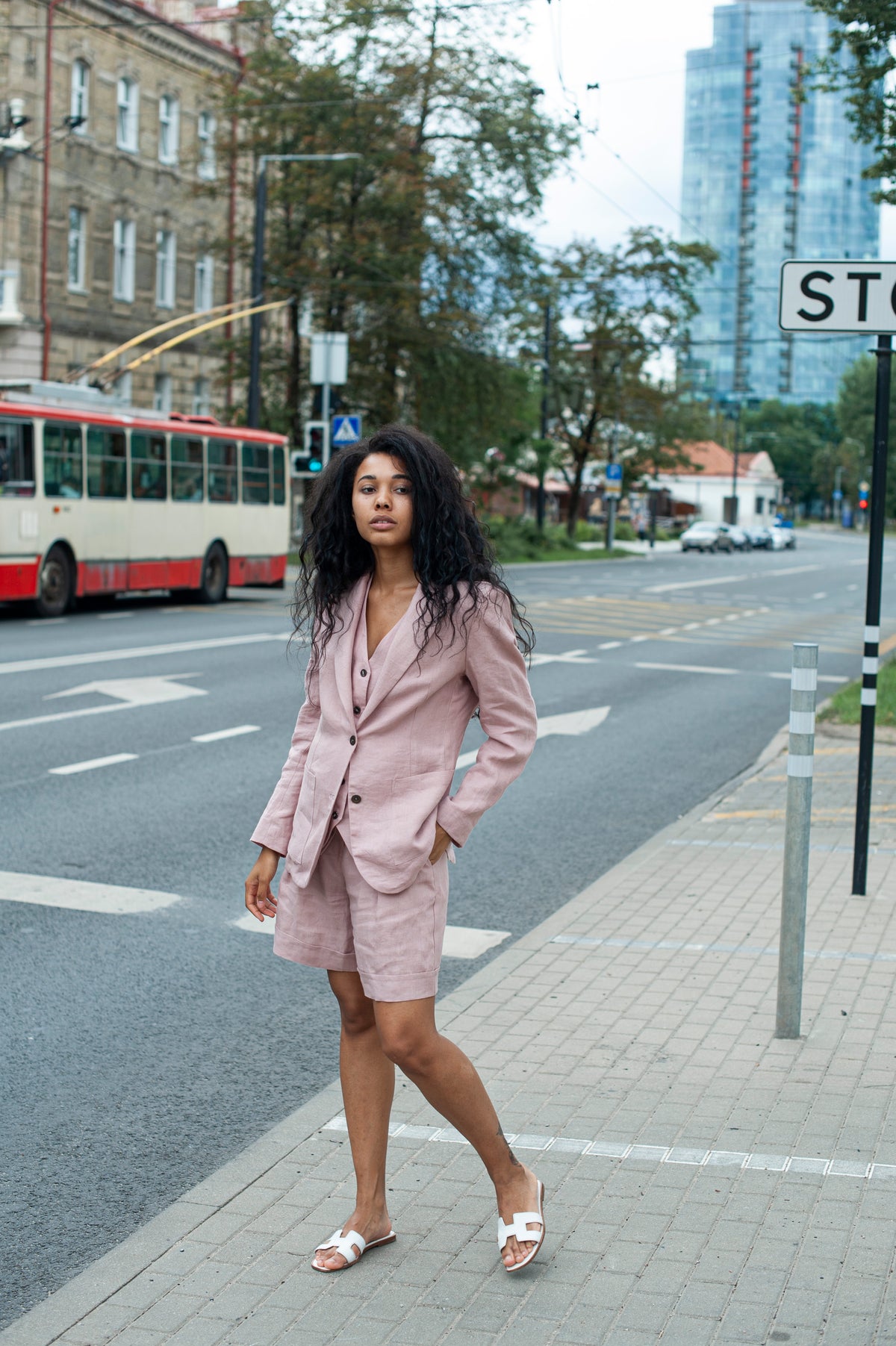 A relaxed dusty pink linen blazer with spacious patch pockets.