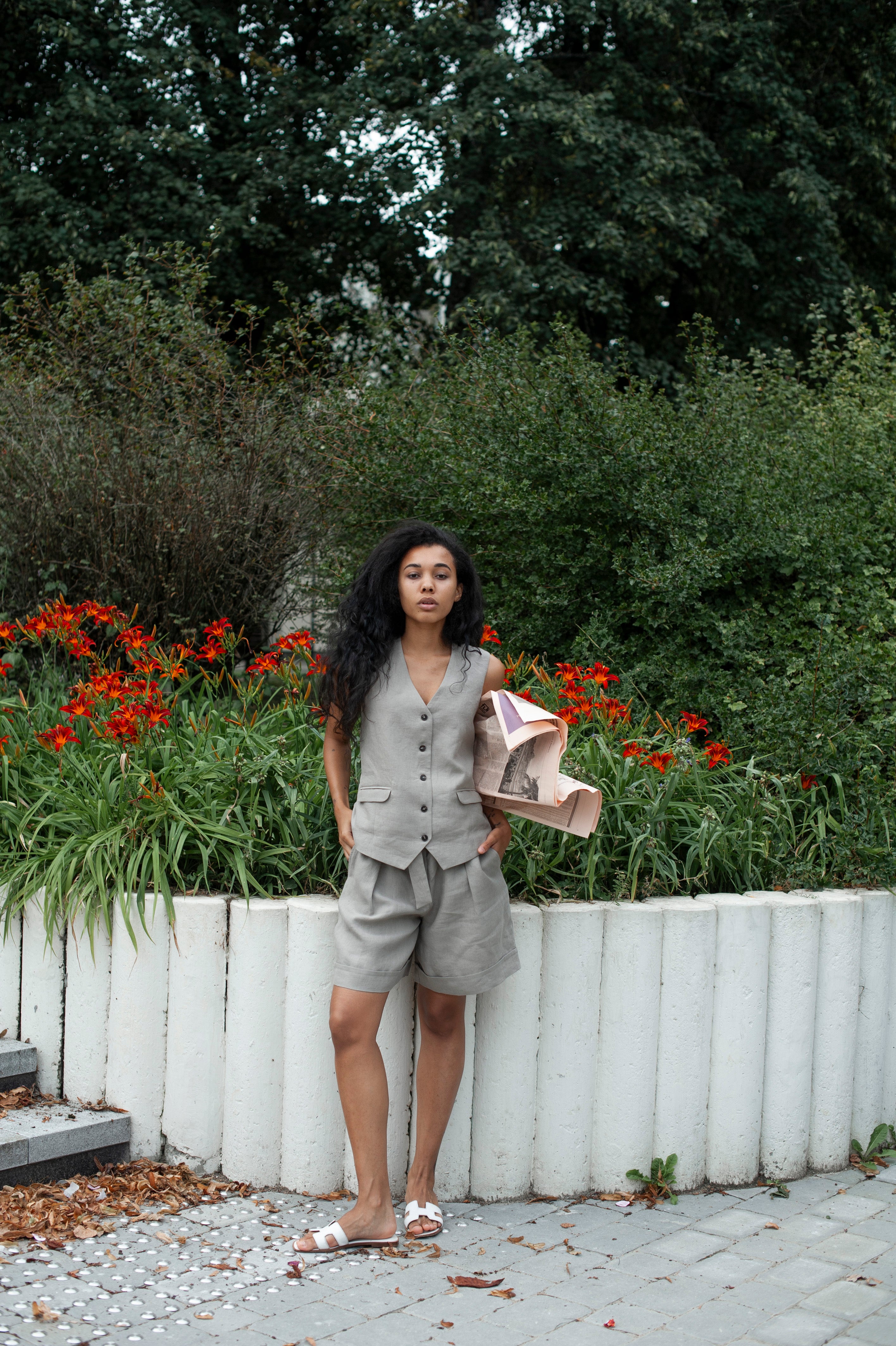 Light grey linen shorts and a matching linen vest. Women's two-piece set for summer.