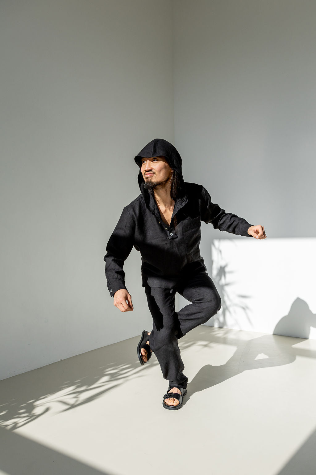 Men's linen co-ord set of a linen hooded shirt and matching tapered leg pants boasting a drawstring.