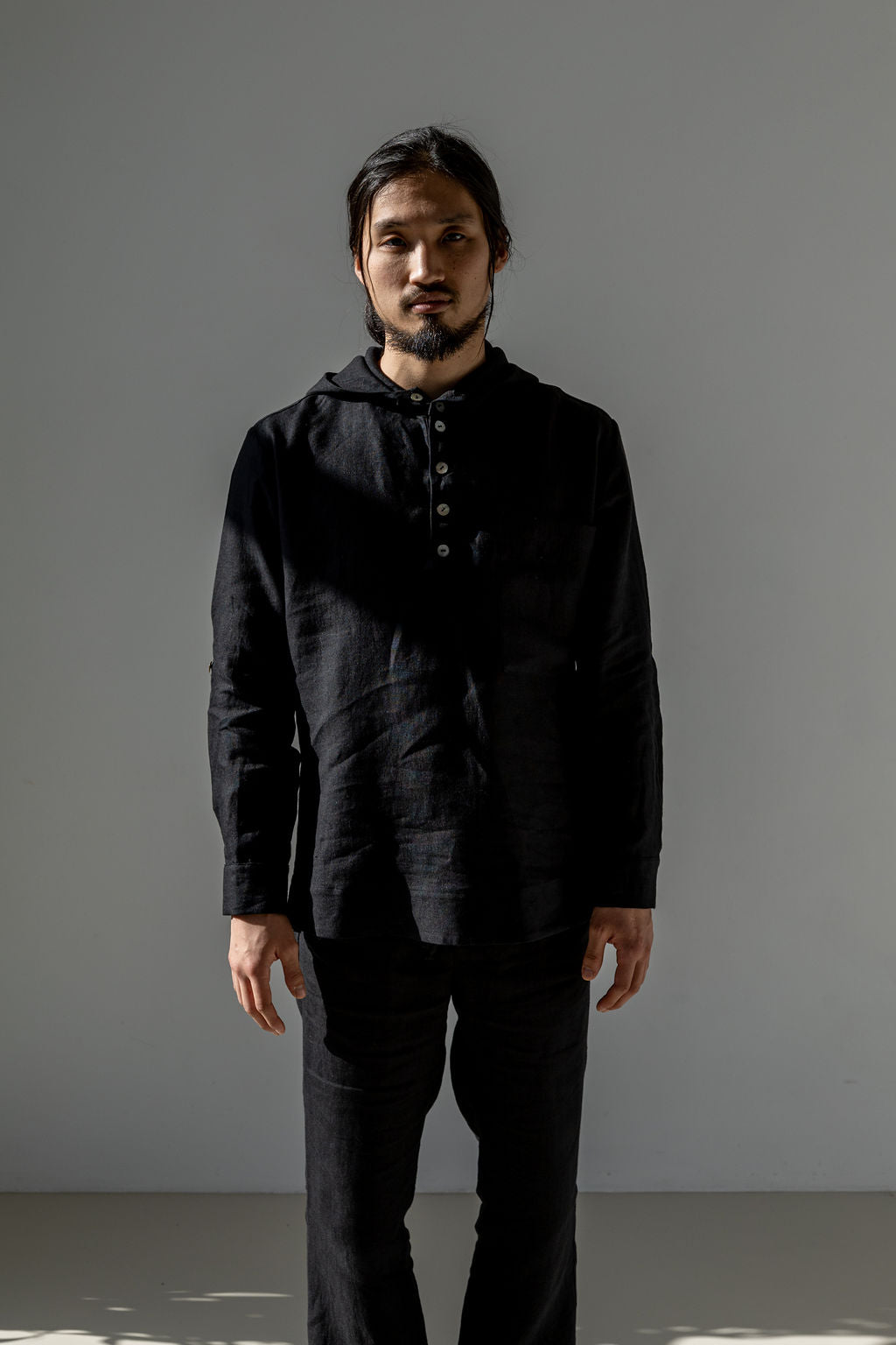 Minimalist linen hoodie with a button closure and chest pocket