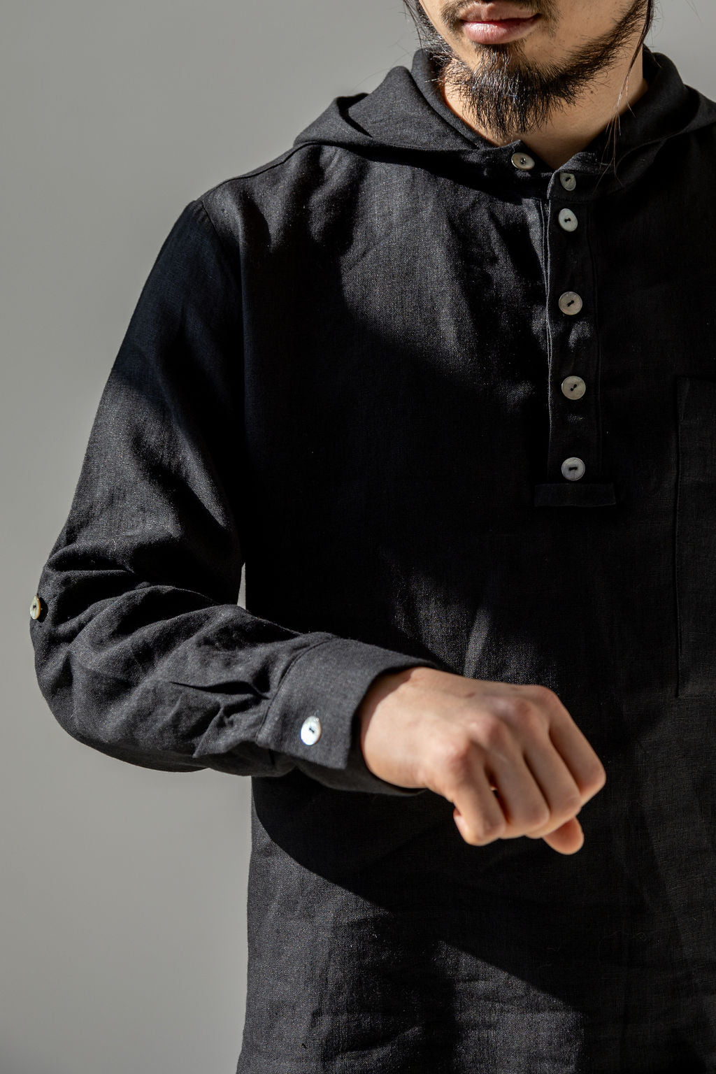 Adjustable sleeves that can be rolled to the elbows and secured with a button fastening