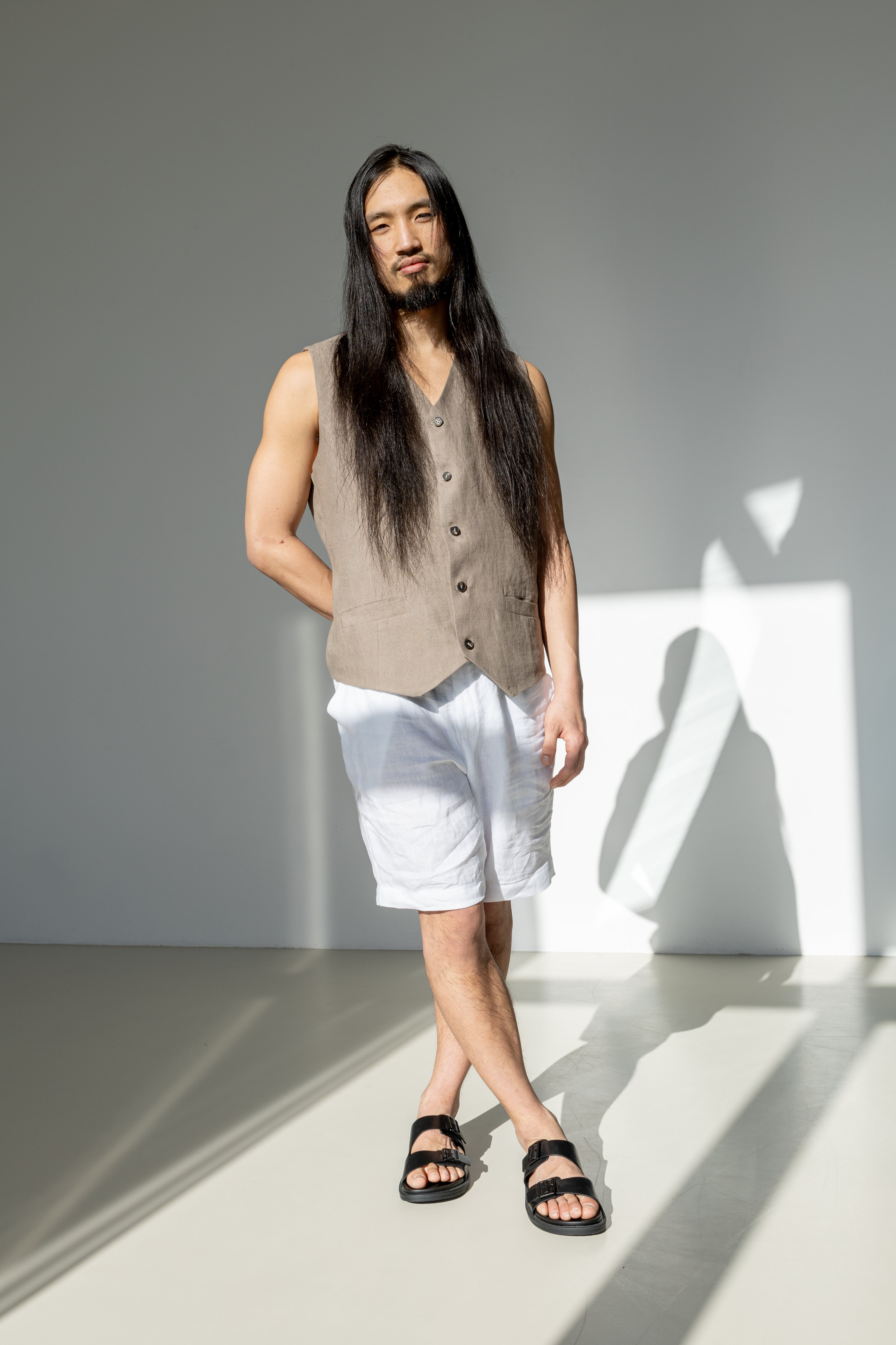 Beige linen suit vest and white linen shorts.