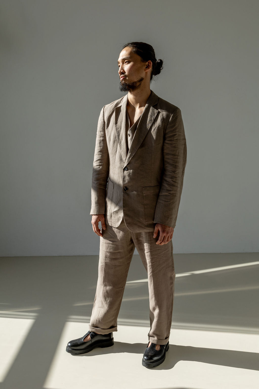 Beige linen suit featuring a classic tailored blazer, waistcoat, and matching pants