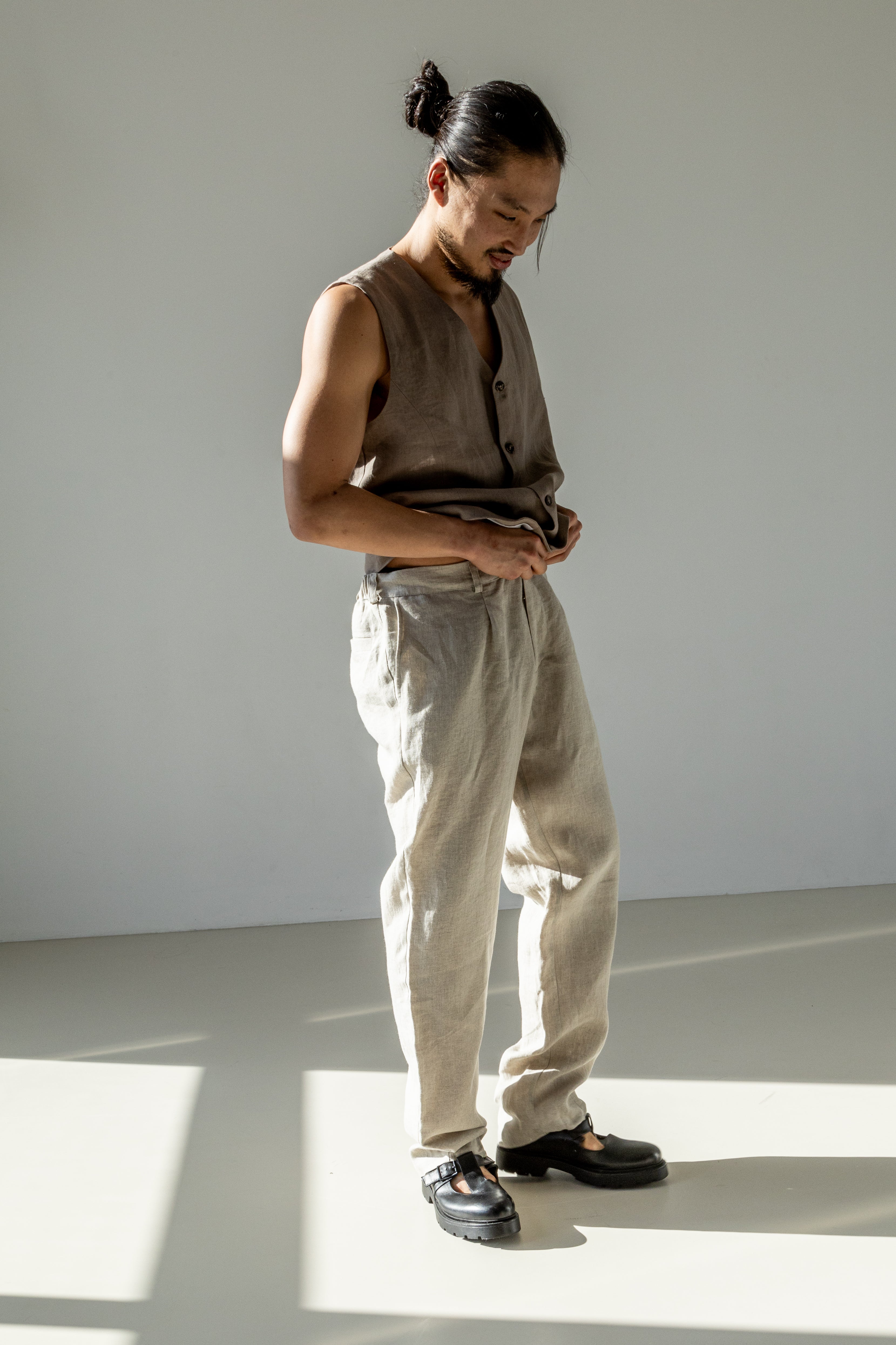 Natural linen grey pants dialed up with a beige linen waistcoat.