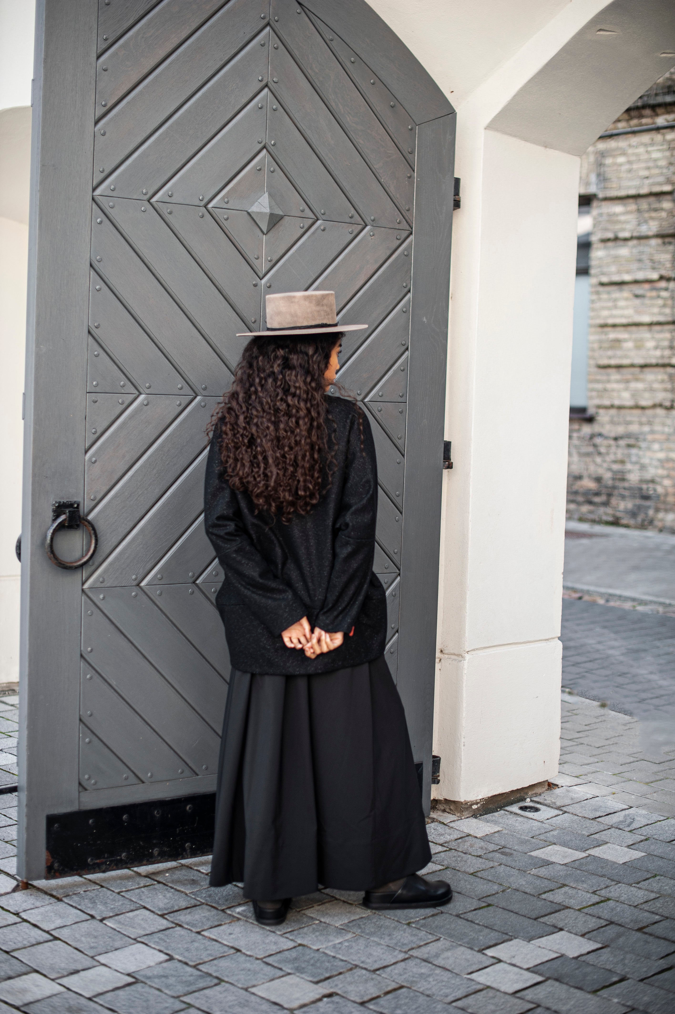 An outfit featuring a black ankle-length wool skirt and a relaxed jacket.