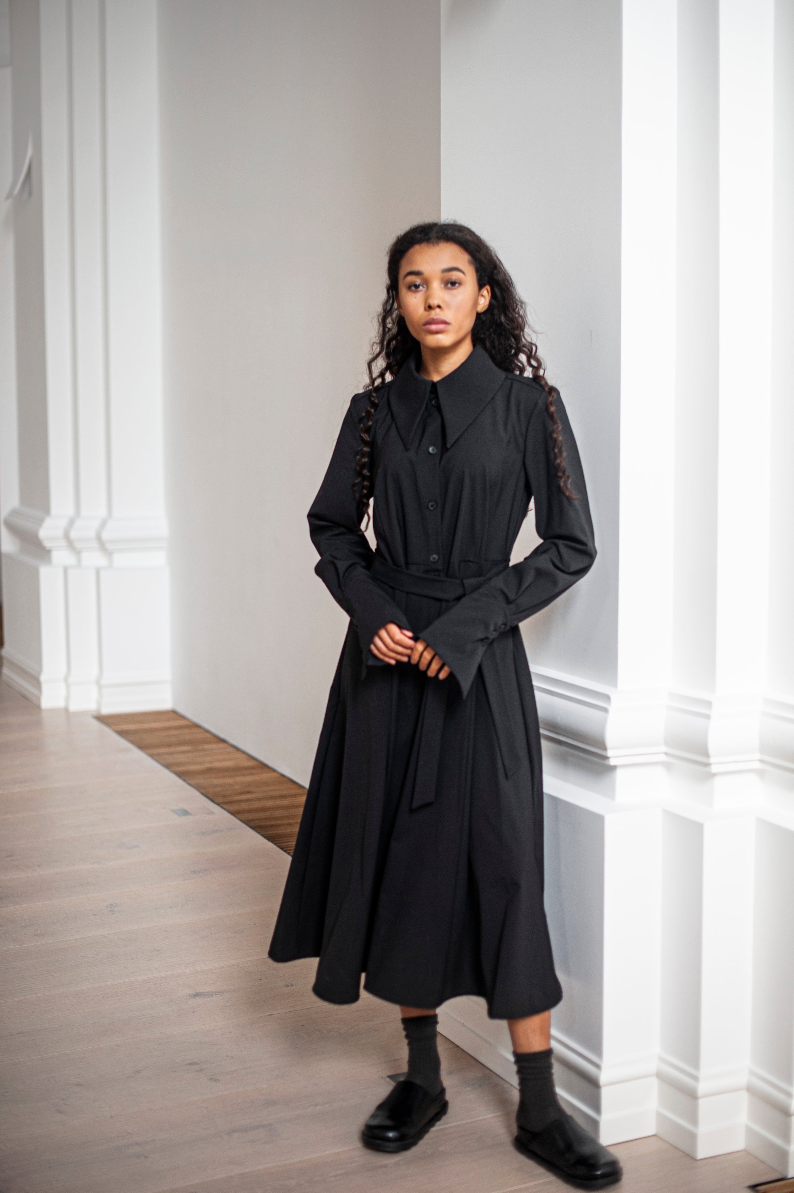 Black luxurious wool dress with French cuffs and a belt for extra elegance.