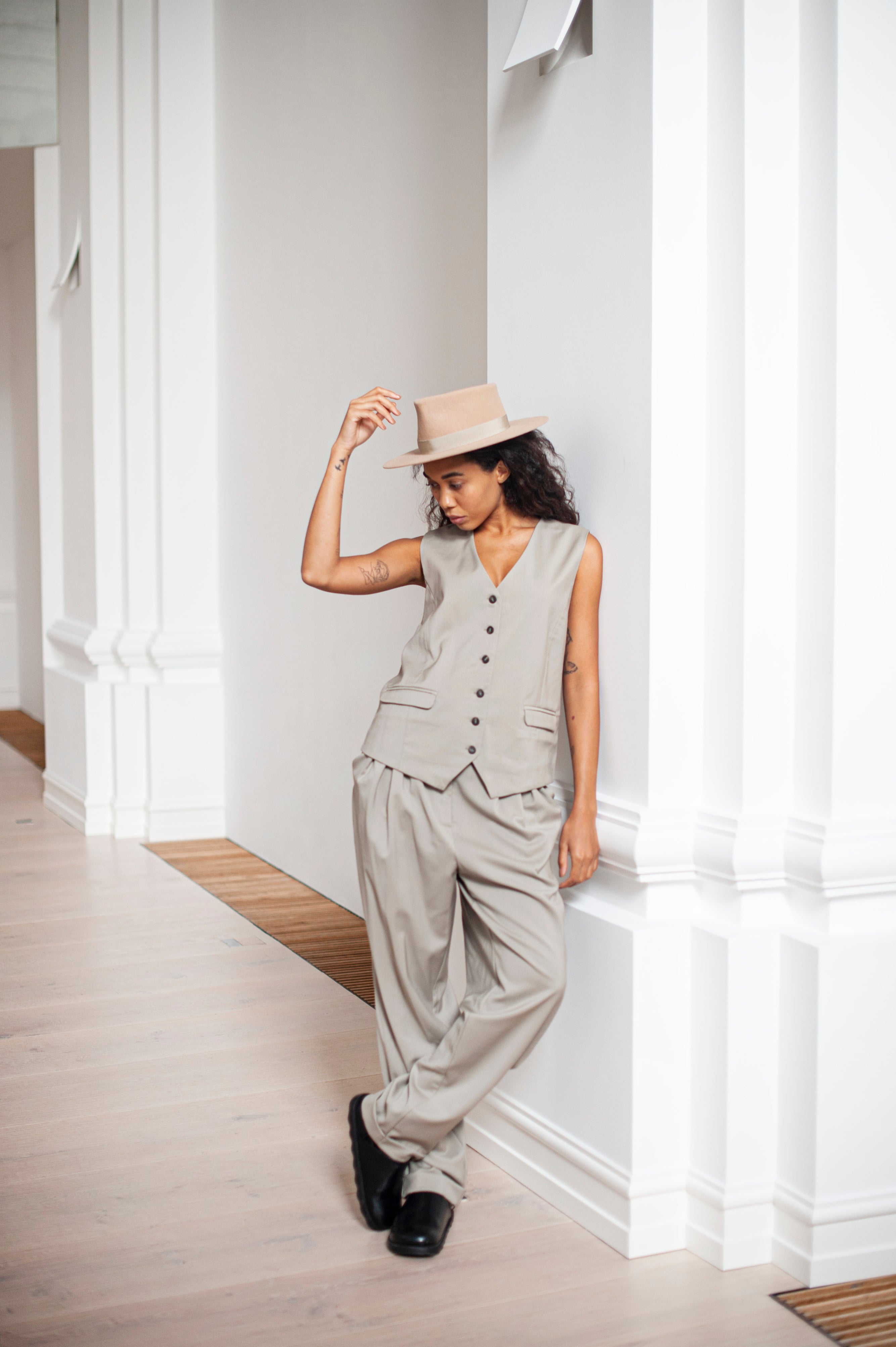 A two-piece outfit of green beige banana trousers and a matching waistcoat.