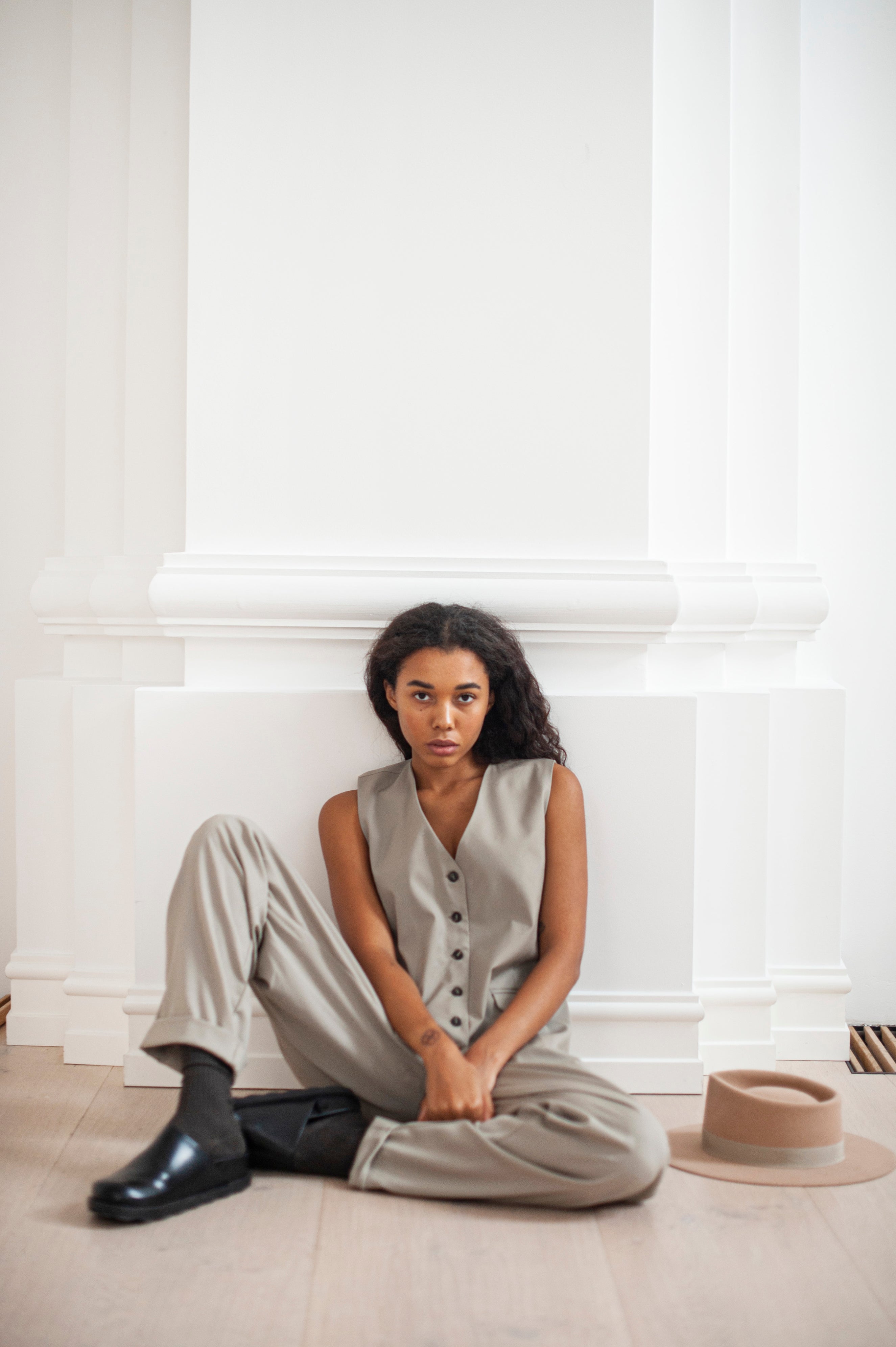 An outfit of a minimalist vest and tapered-let banana pants with rolled ends