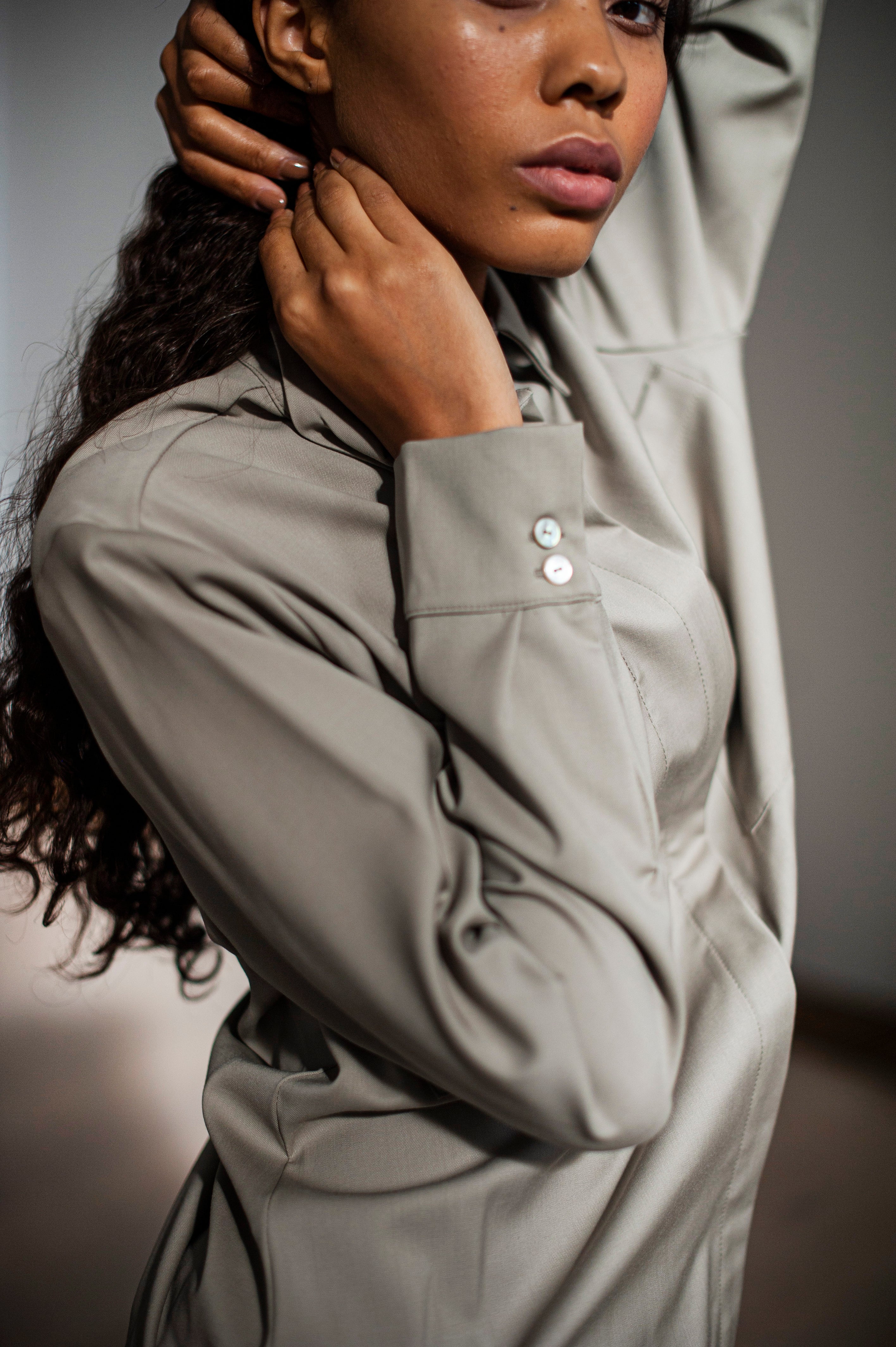 Women's button-up wool shirt with a collar, back pleat, and two front pockets.