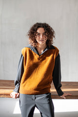 Rust brown knitted Merino wool sweater vest dialed up with a black co-ord set.