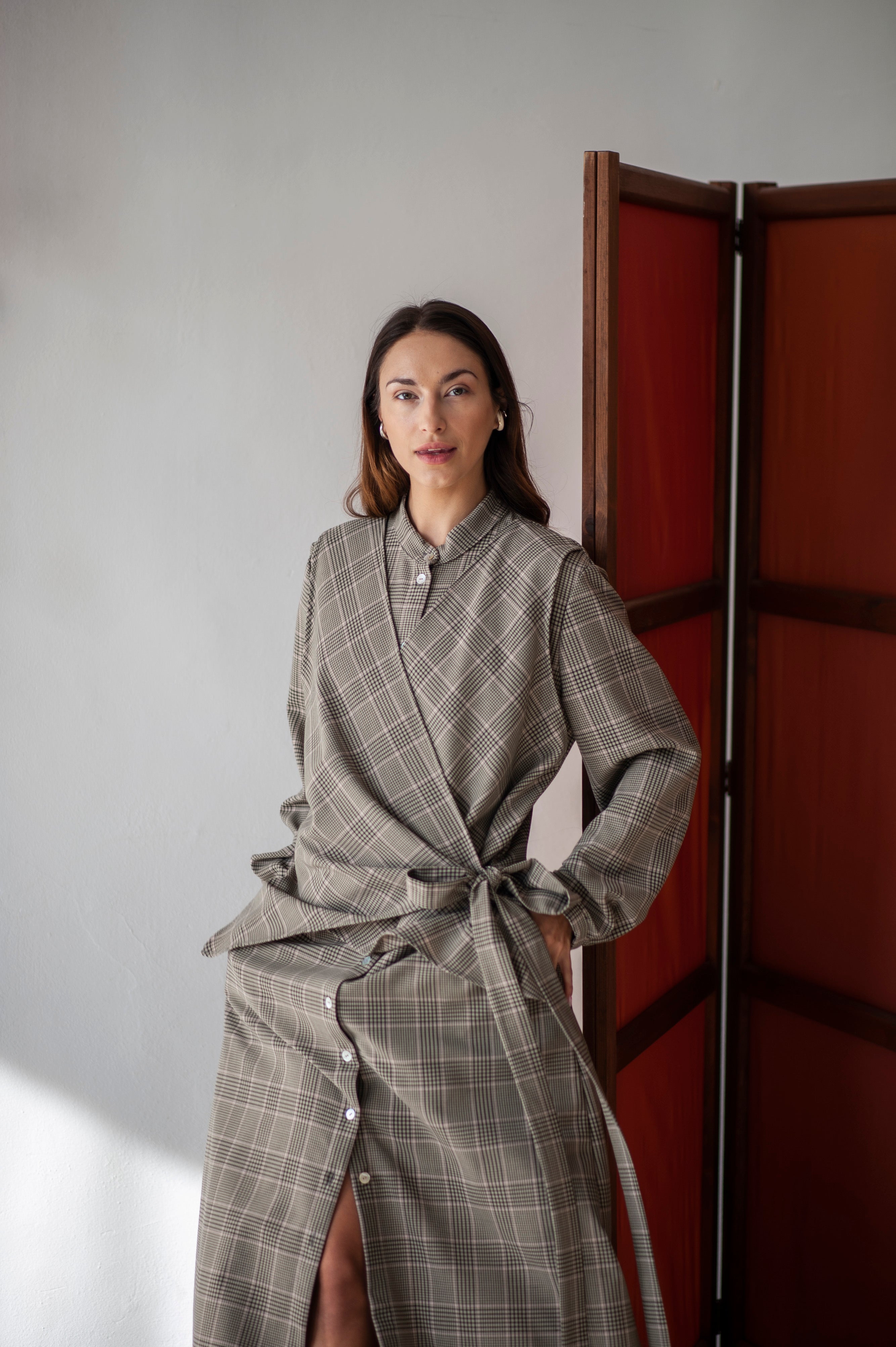 Grey plaid A-line dress with a wrap detail in the front.