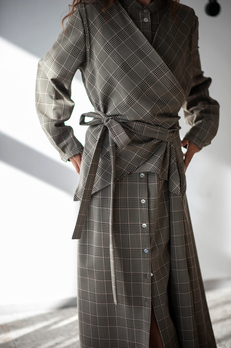Elegant grey plaid wool dress with a buttoned front and a wrap detaill.