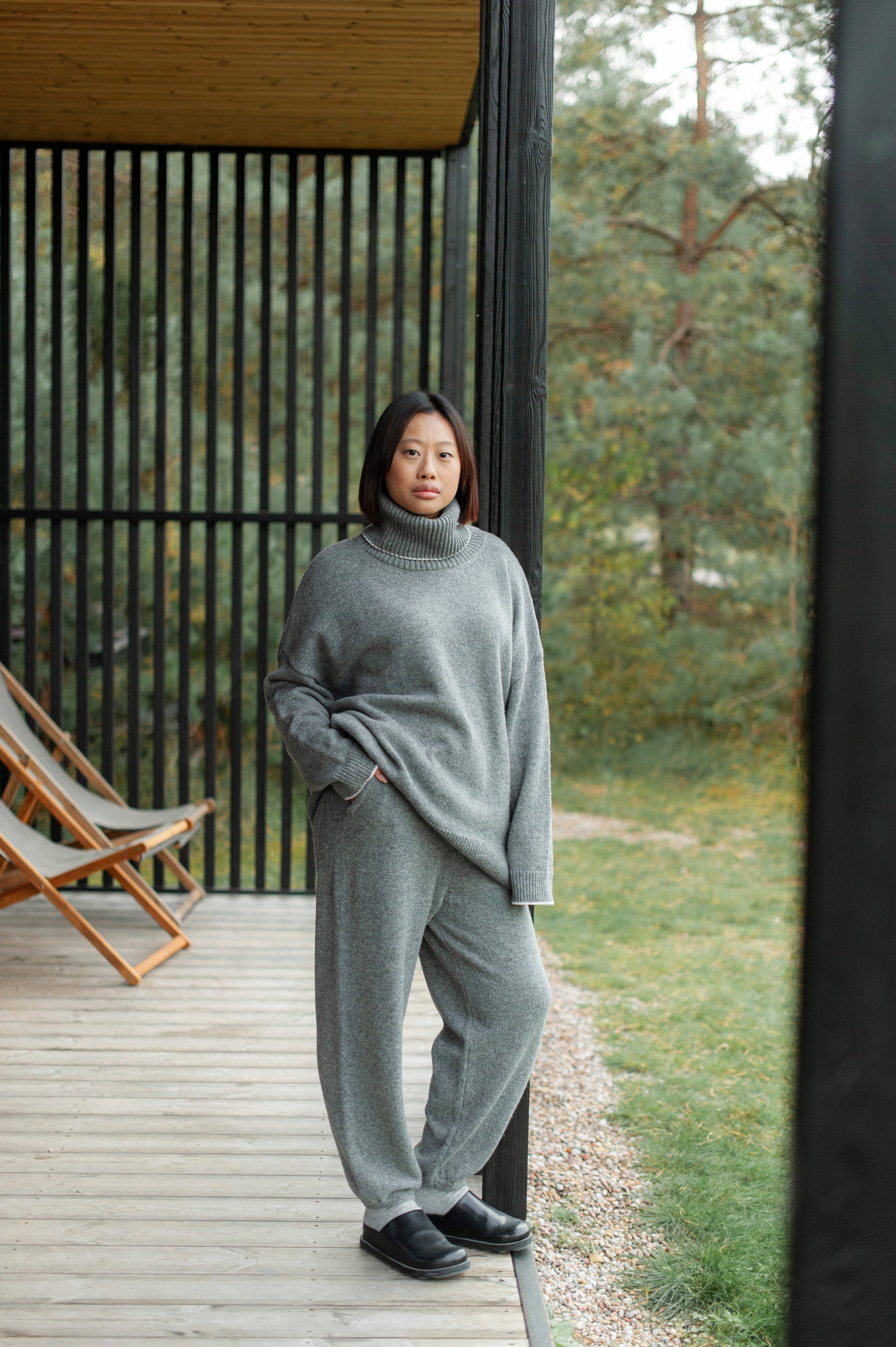 Grey merino wool outfit of an oversized fit high-neck sweater and knit barrel pants.