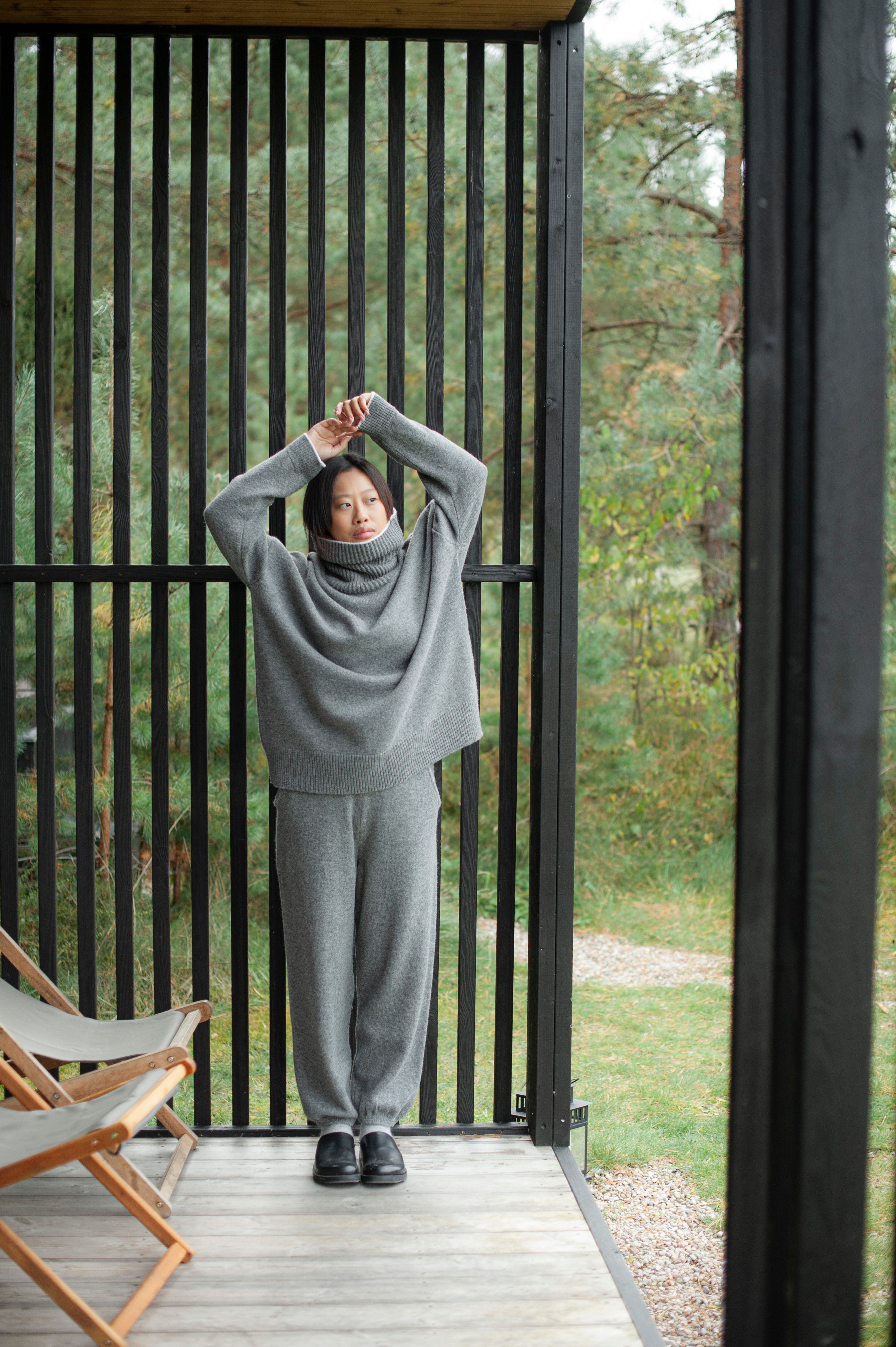 Grey merino wool outfit of an oversized fit high-neck sweater and knit barrel pants.