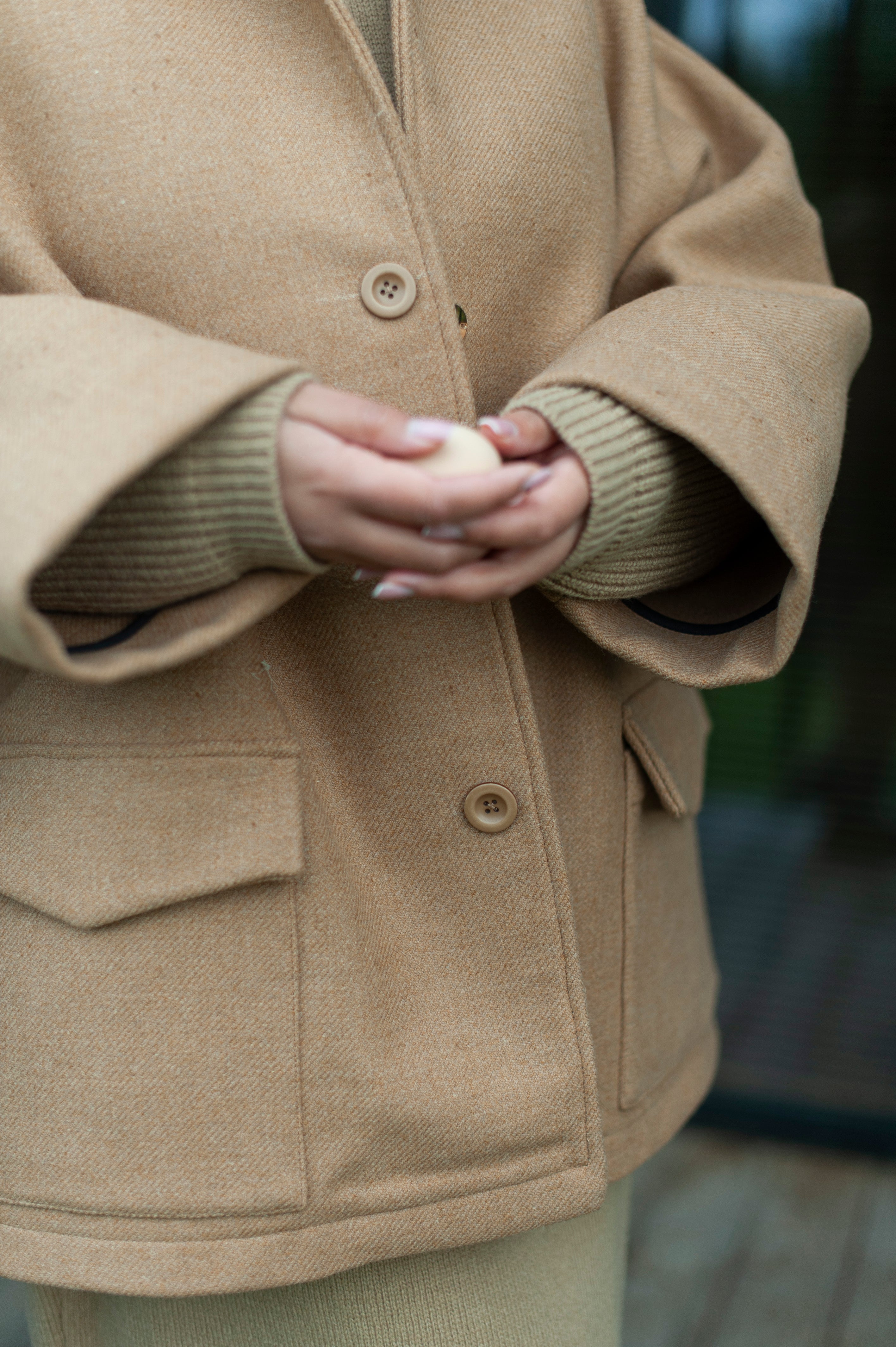 Camel color oversized one-size jacket made of double-cloth high quality wool. The jacket boasts a lapel color, dropped shoulders, wide sleeves and two spacious patch pockets with flaps.