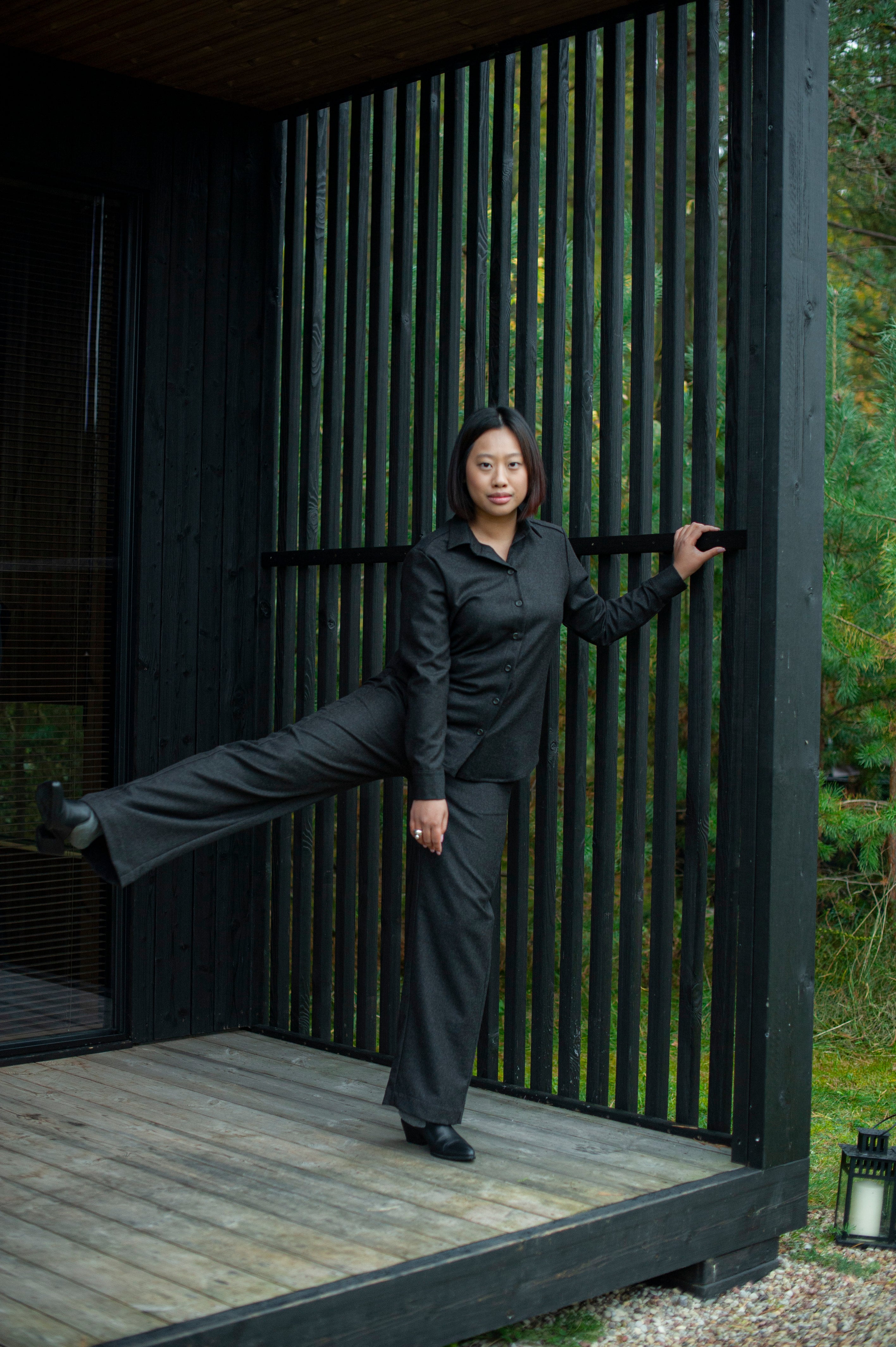 Brown wool trousers paired with a matching button-up shirt.