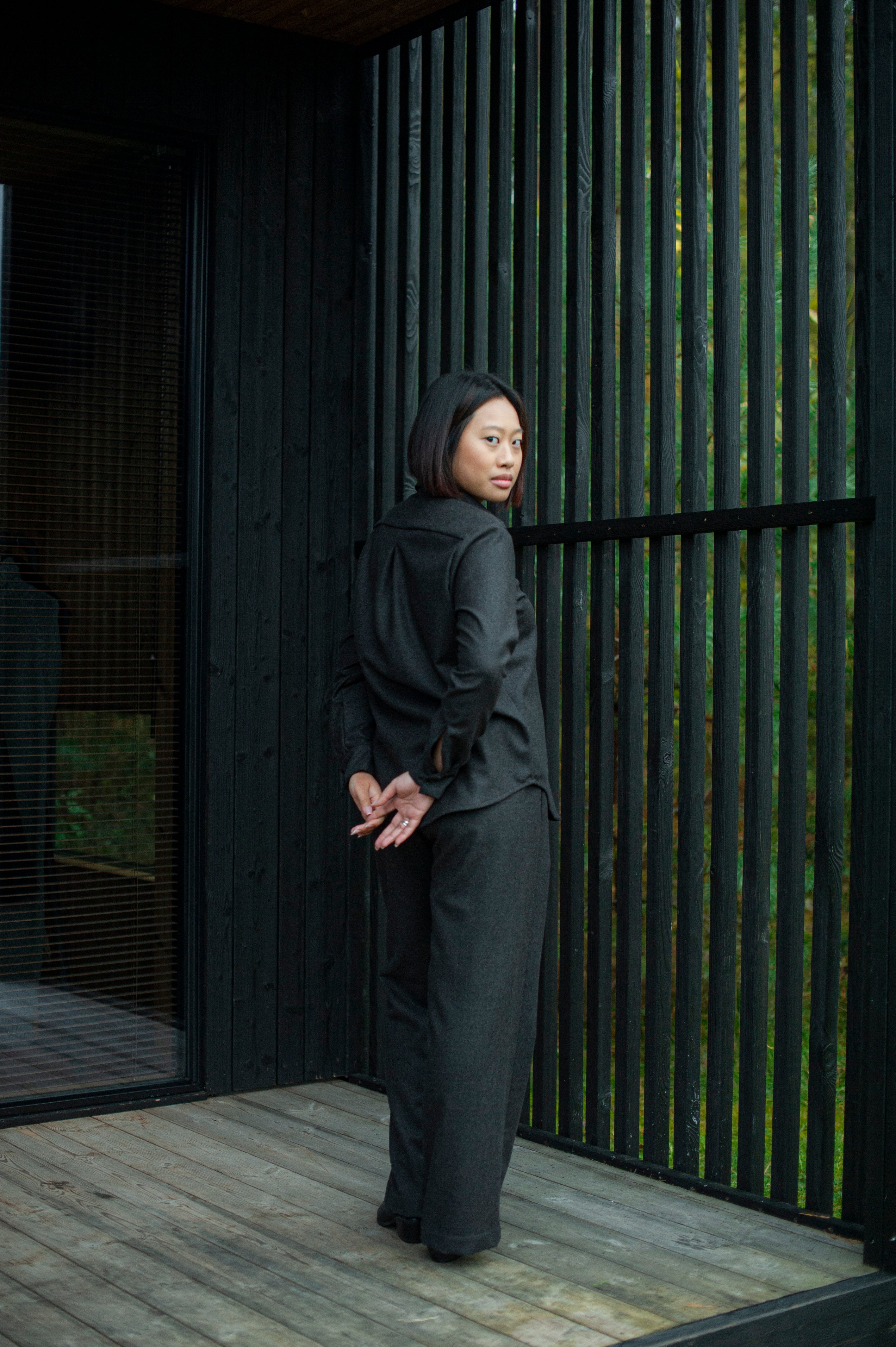 Women’s brown wool Oxford shirt with a relaxed straight fit and regular collar, paired with matching brown straight-leg pants for a minimalist, elegant look.