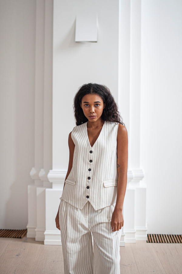 White pinstripe vest paired with matching wide-leg pants