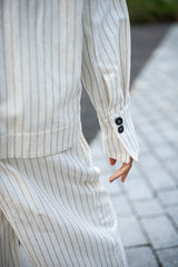 White organic cotton fabric with stripes. Minimalist one-size jacket with French cuffs