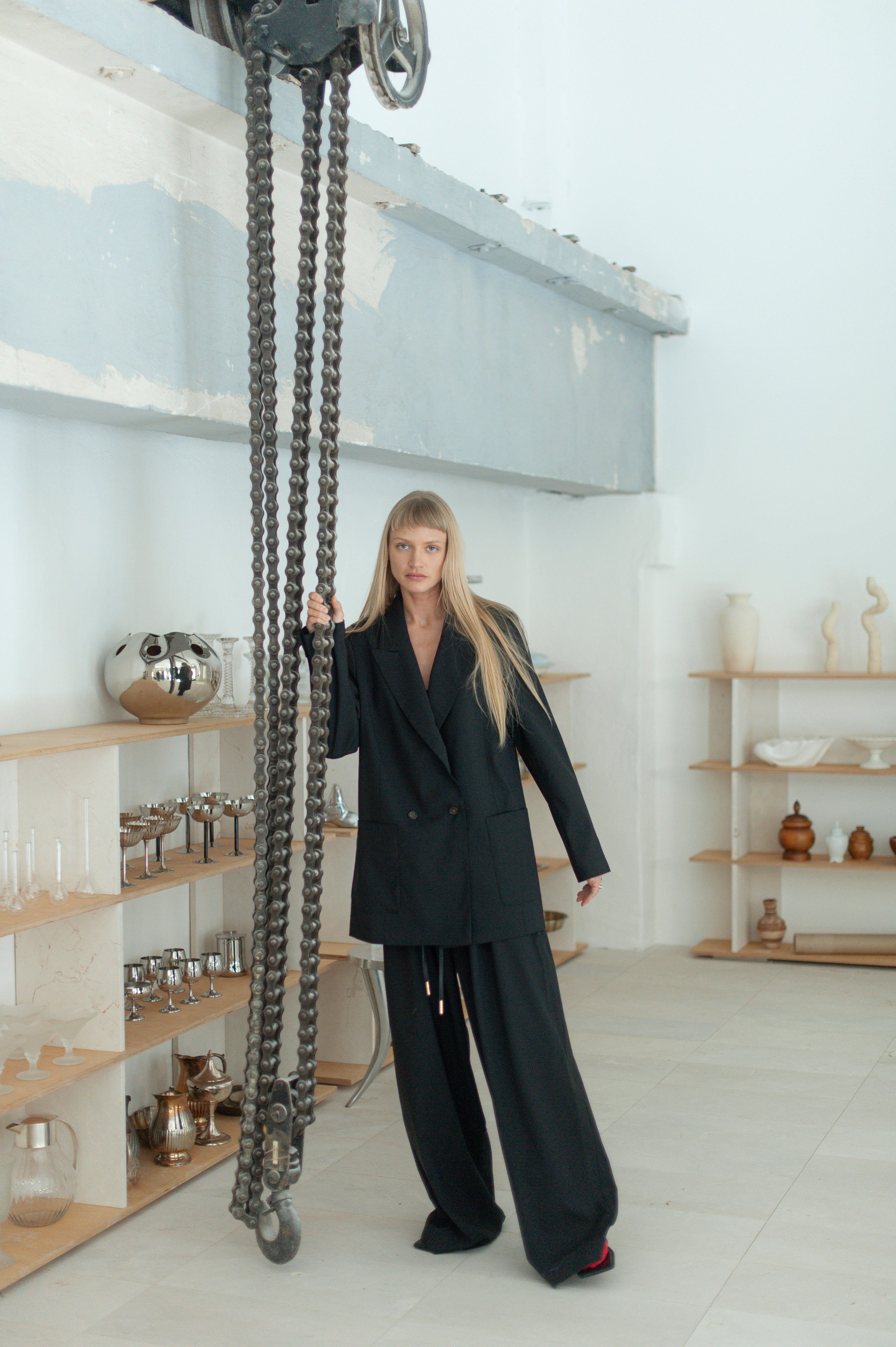 Blonde model wearing wide-leg wool pants with a matching double-breasted blazer.