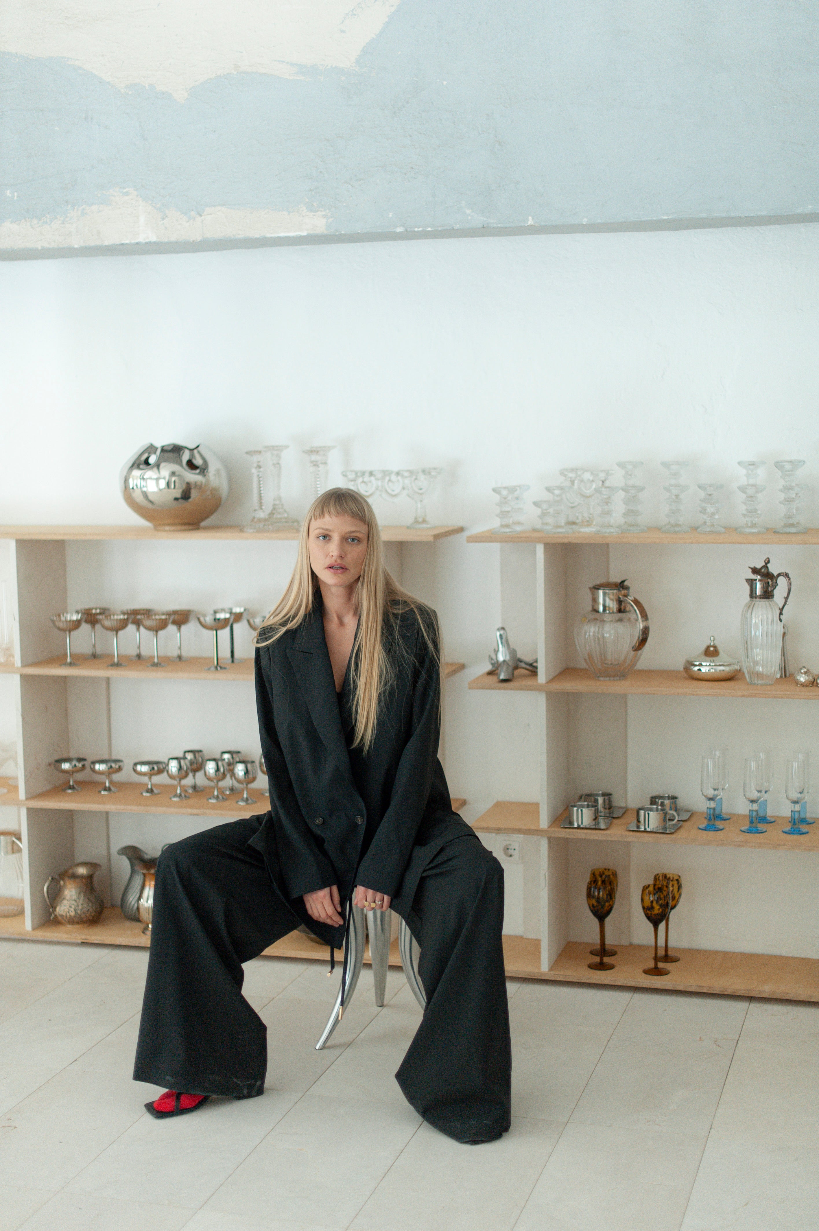 Blonde woman in flowing wool pants paired with a structured blazer.