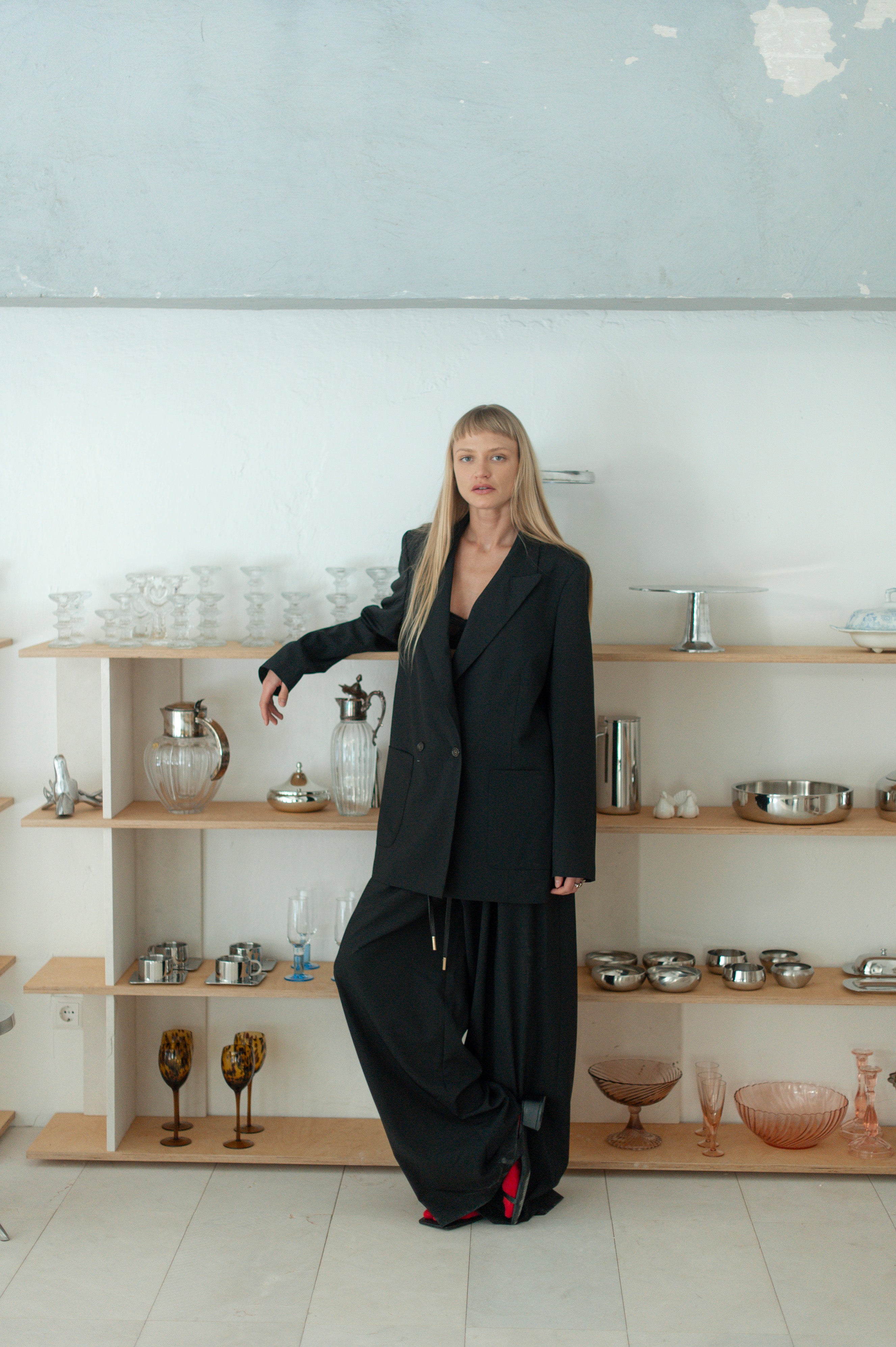 Soft wool wide-leg pants and matching blazer on a model, contemporary minimalist look.