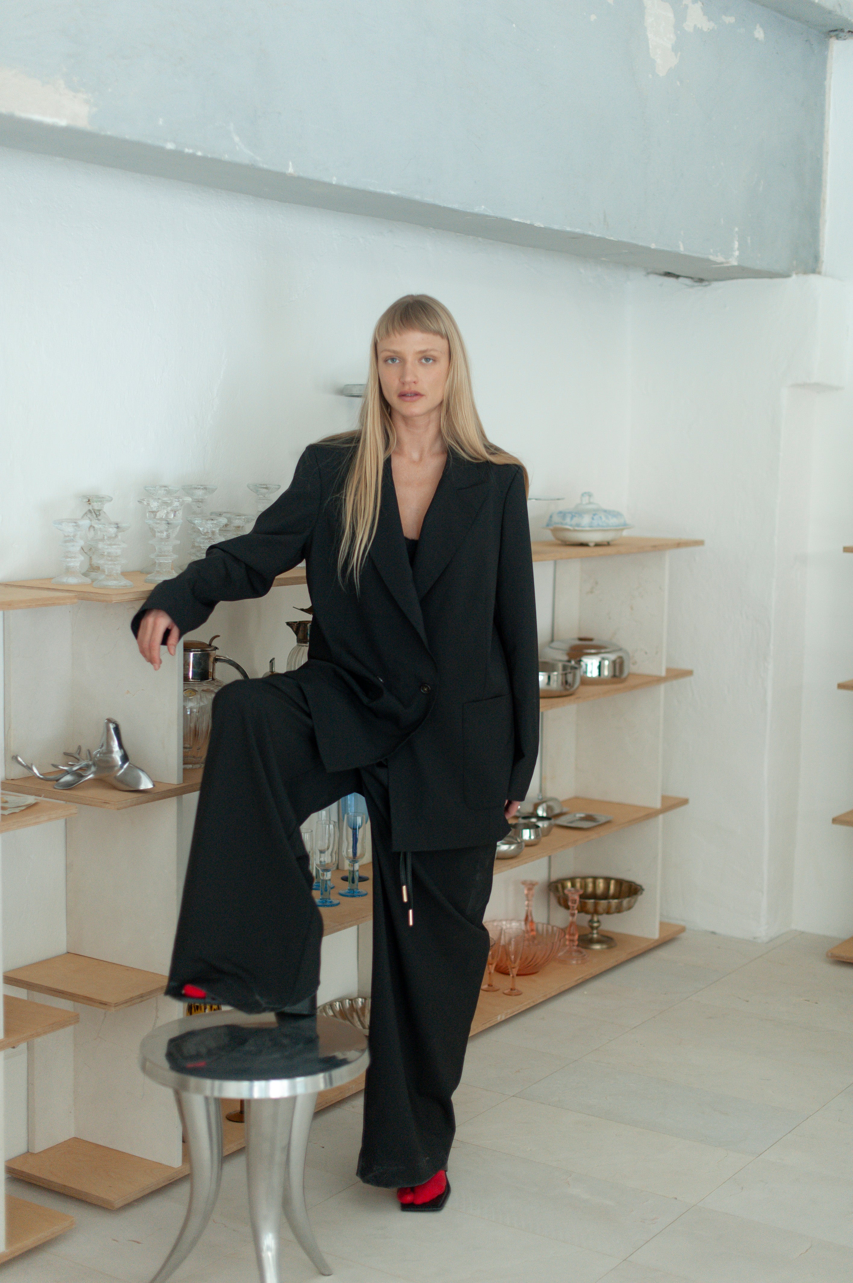 Minimalist wool pants with relaxed fit, worn with matching blazer.