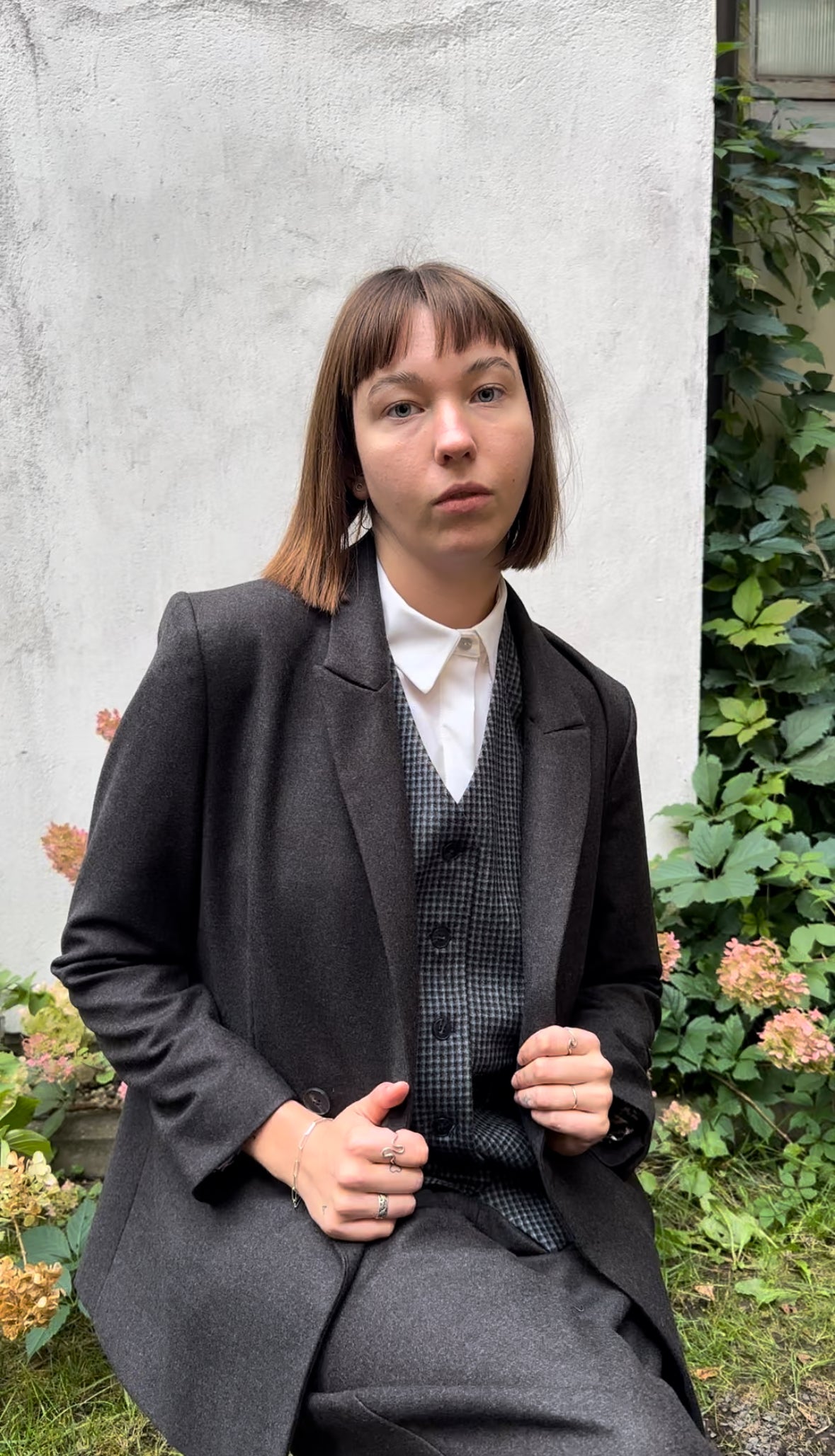 Brown double-breasted wool blazer with a blue check suit vest. The ensemble is paired with a white merino wool collar shirt for a put-together look.