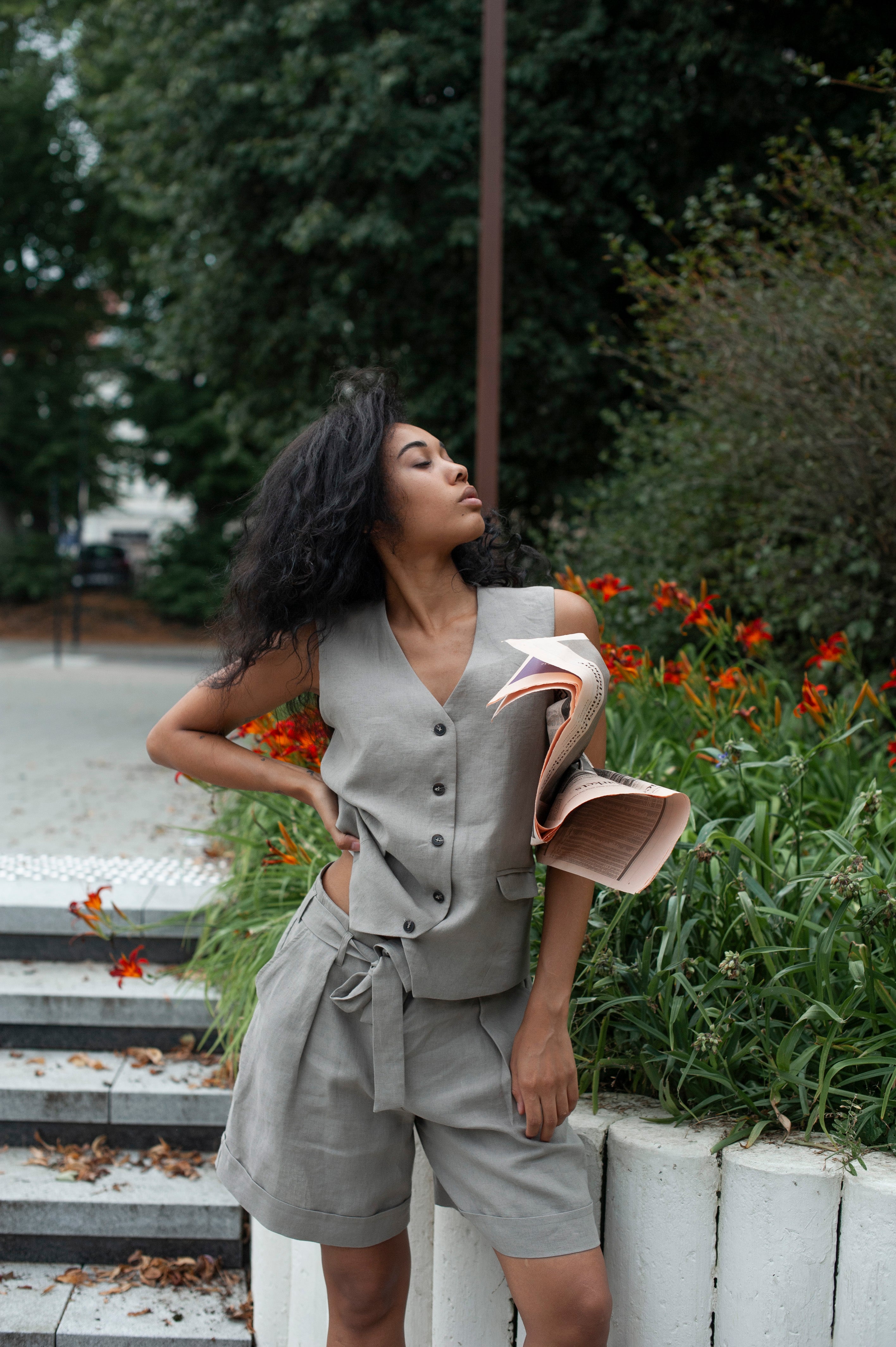 Women's two-piece linen set of a linen suit vest and wide-leg shorts in light grey.