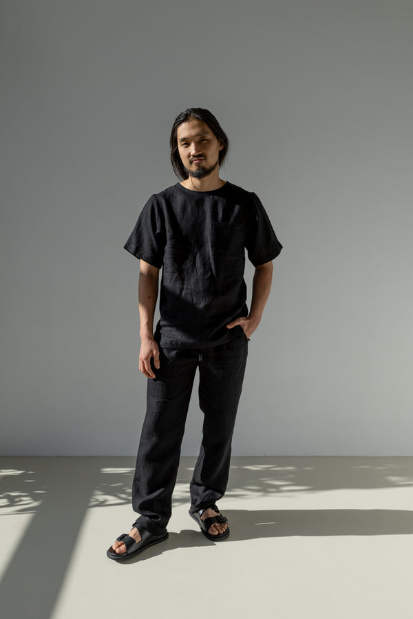 Men's classic linen tapered leg pants with side pockets and a drawstring paired with a loose-fit linen T-shirt