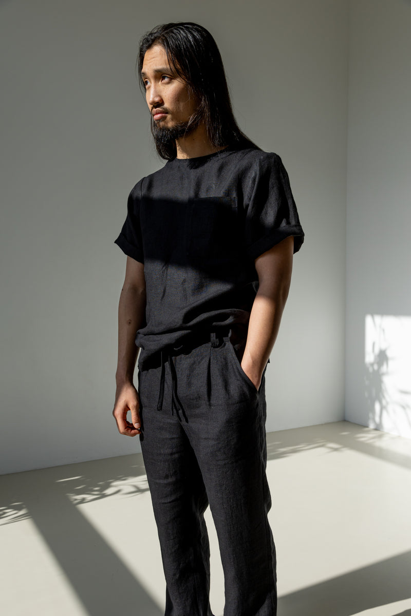 Men's linen co-ord set of a black linen T-shirt and classic linen pants boasting a drawstring