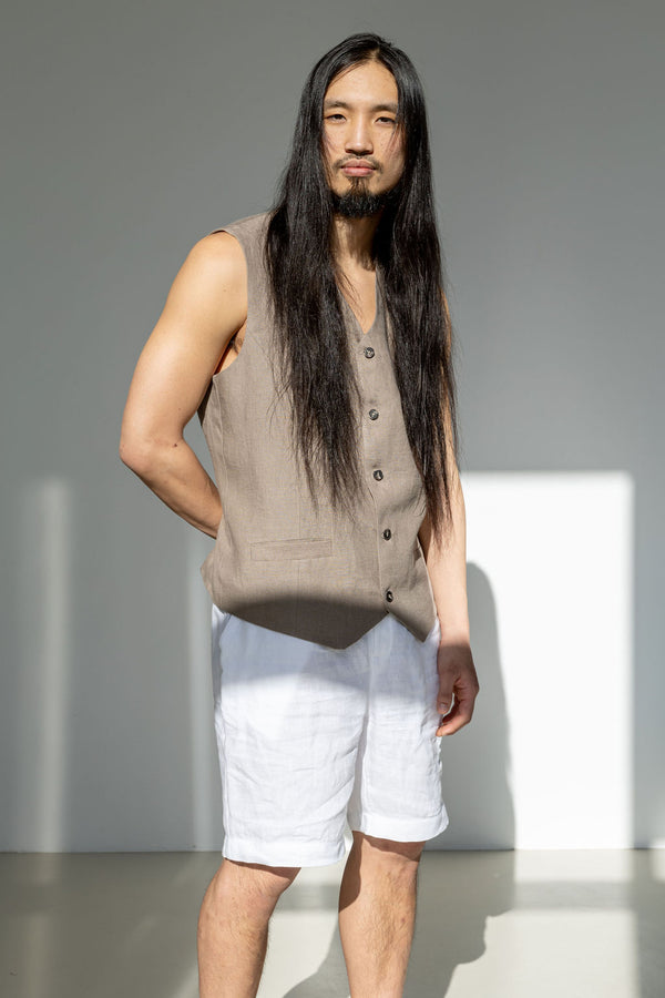 Men's outfit featuring a beige linen suit vest and relaxed-fitting white linen shorts