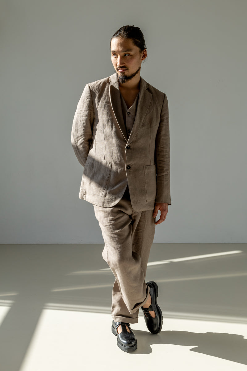 Men's three-piece linen suit of a blazer, waistcoat, and loose-fitting pants