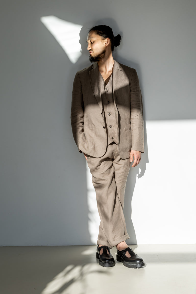 Men's three-piece linen suit of a blazer, waistcoat, and loose-fitting pants