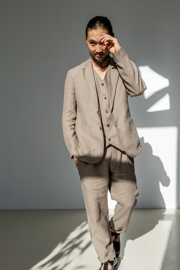 Men's linen blazer paired with a matching waistcoat and relaxed fit pants