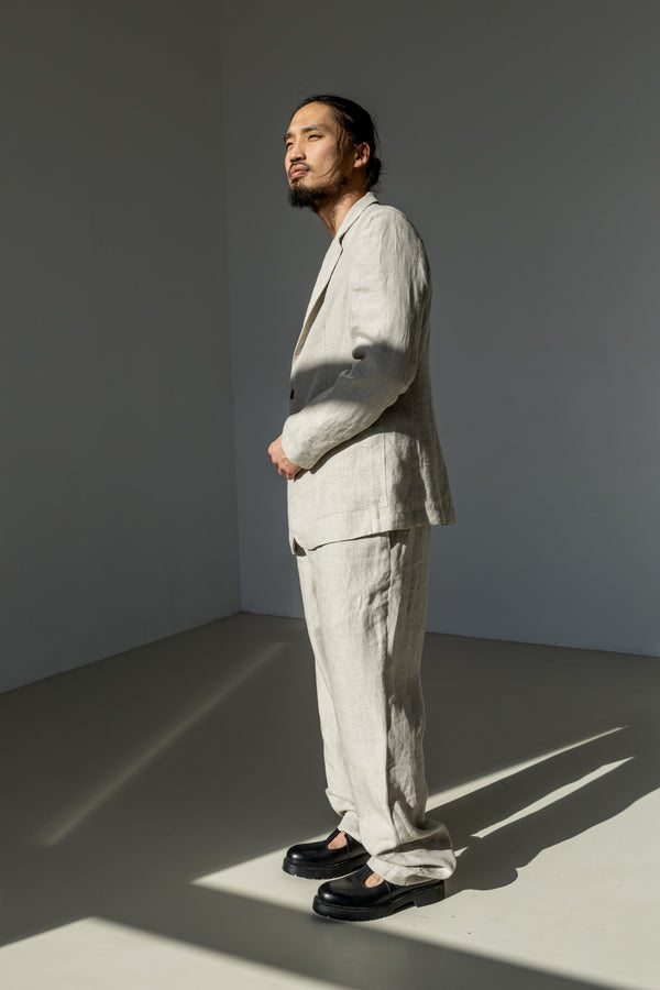 Elegant and timeless flat front linen pants for men dialed up with a matching linen blazer in natural linen grey.