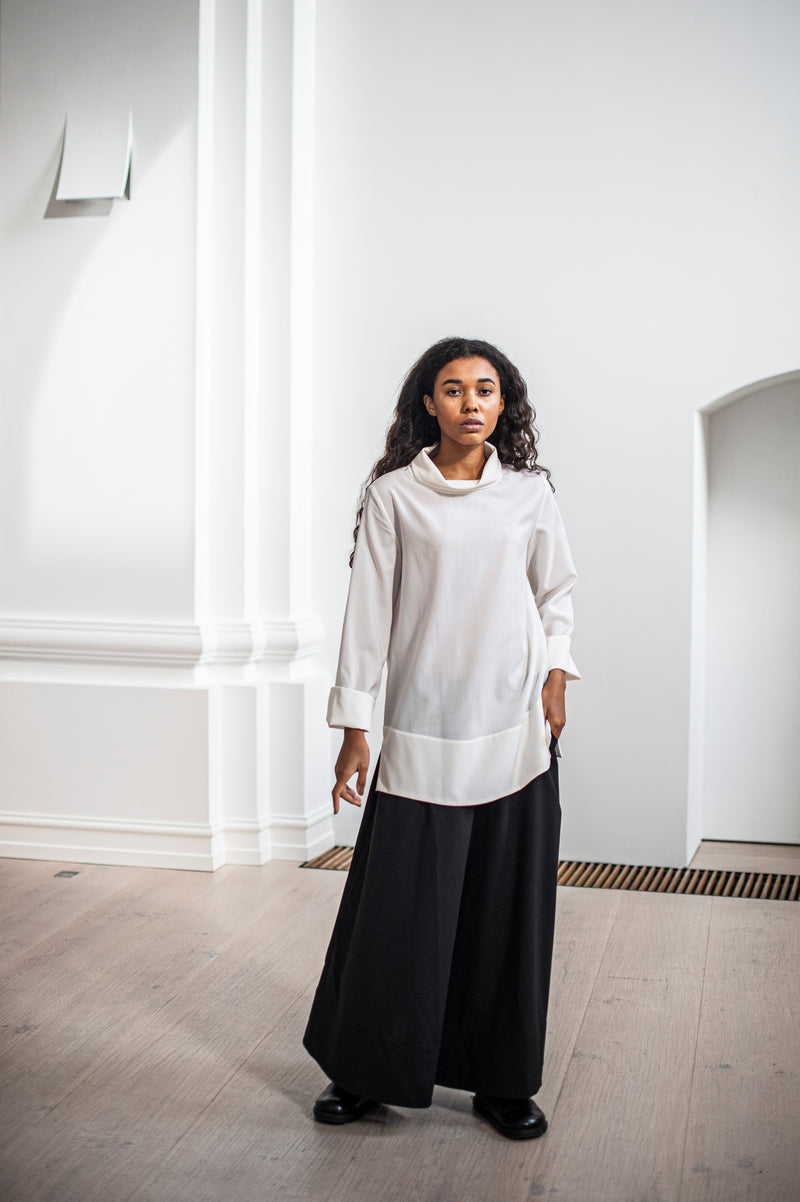 Elegant A-line silhouette wool skirt paired with a classic high-neck blouse