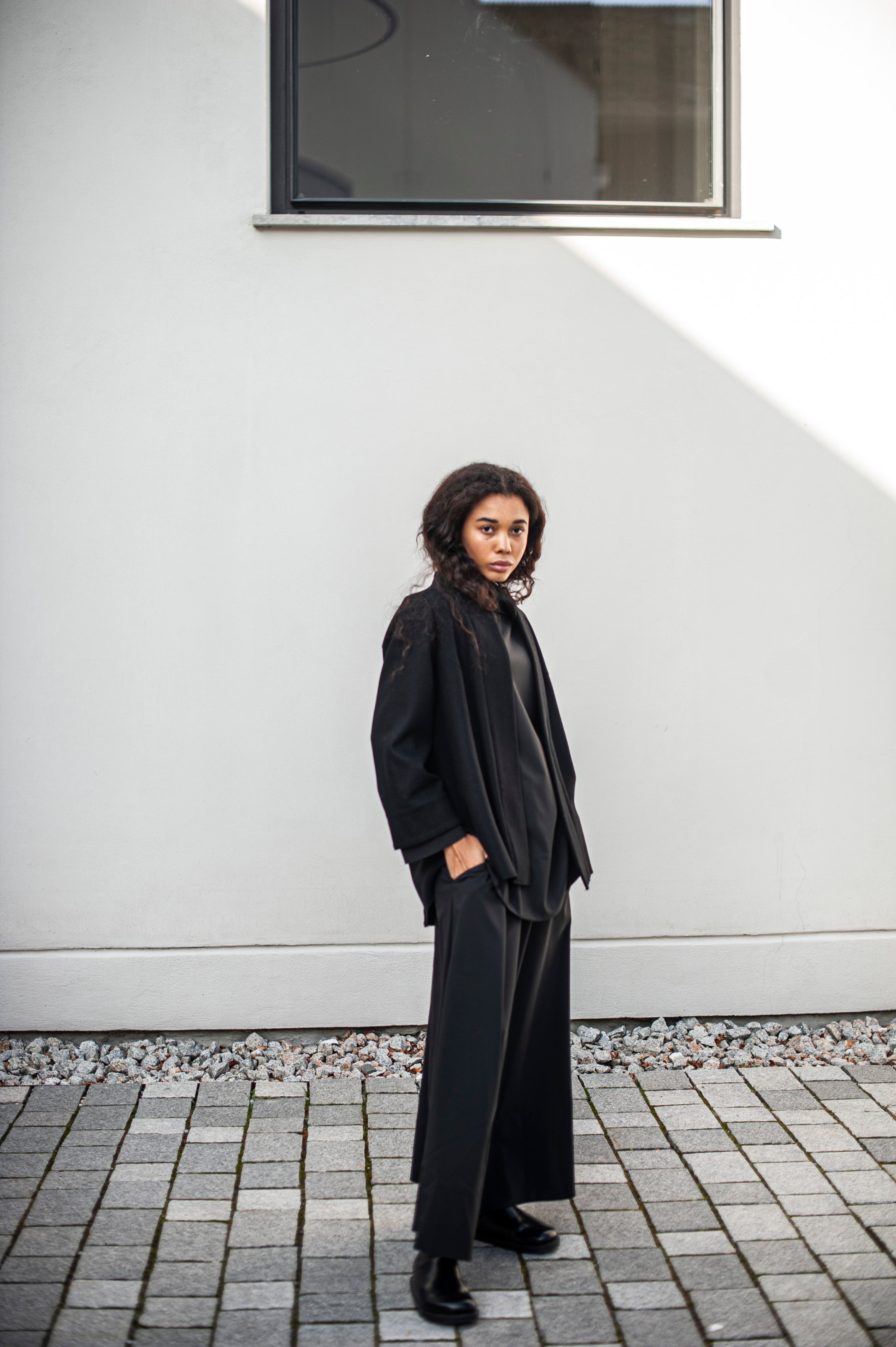 Monochrome outfit of a Japanese constume-inspired blazer and a wide ankle-length black skirt.