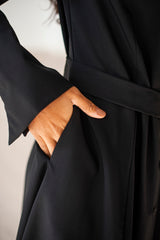 Belted A-line dress with long sleeve ends boasting French cuffs.