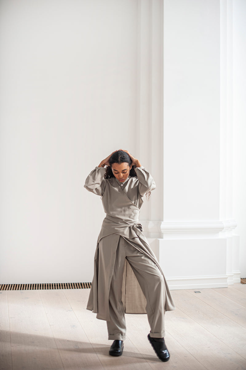 A wool wrap dress paired with matching tapered-leg trousers.