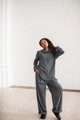 A minimalist grey co-ord of a collar shirt and and pleated pants
