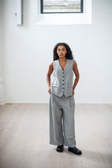 A classic button-up vest and wide-leg trousers with front pleats