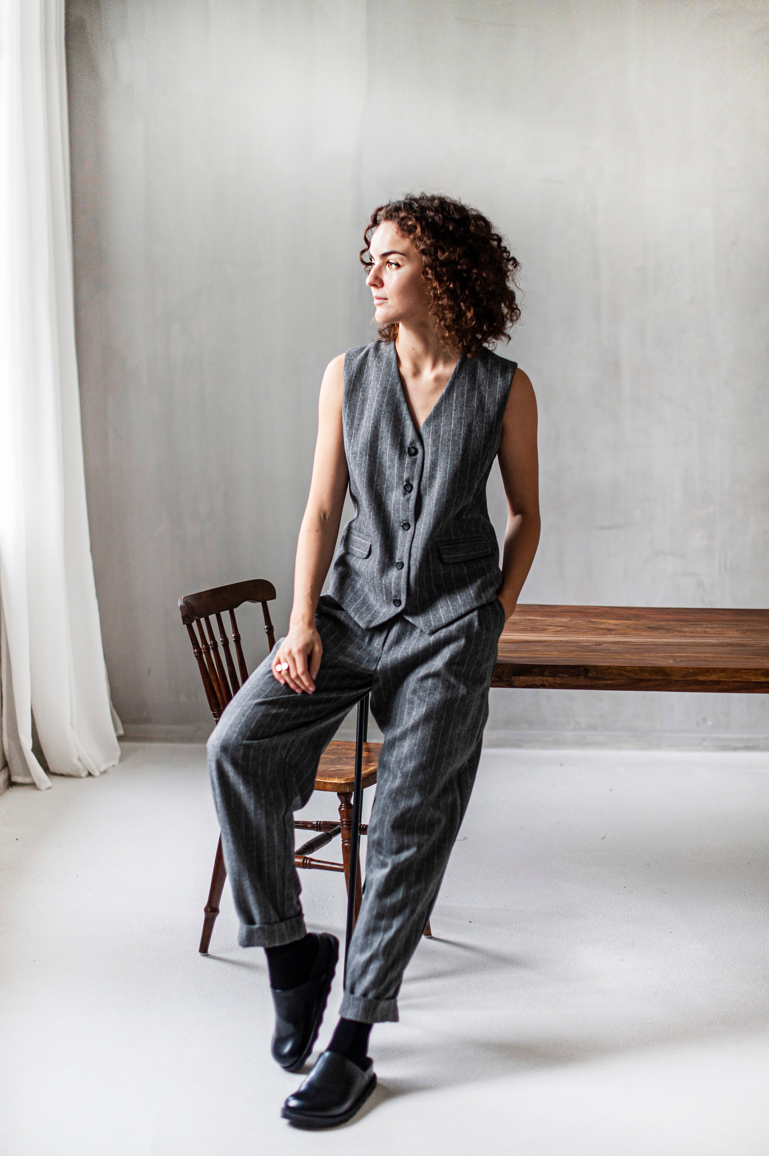 A monochromatic outfit of a pinstripe vest and matching tapered leg pants. The vest suit is made of high-quality wool. Handmade clothes for women.