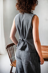 A classic wool waist in grey stripes with a cinched bag for a slimmer fit