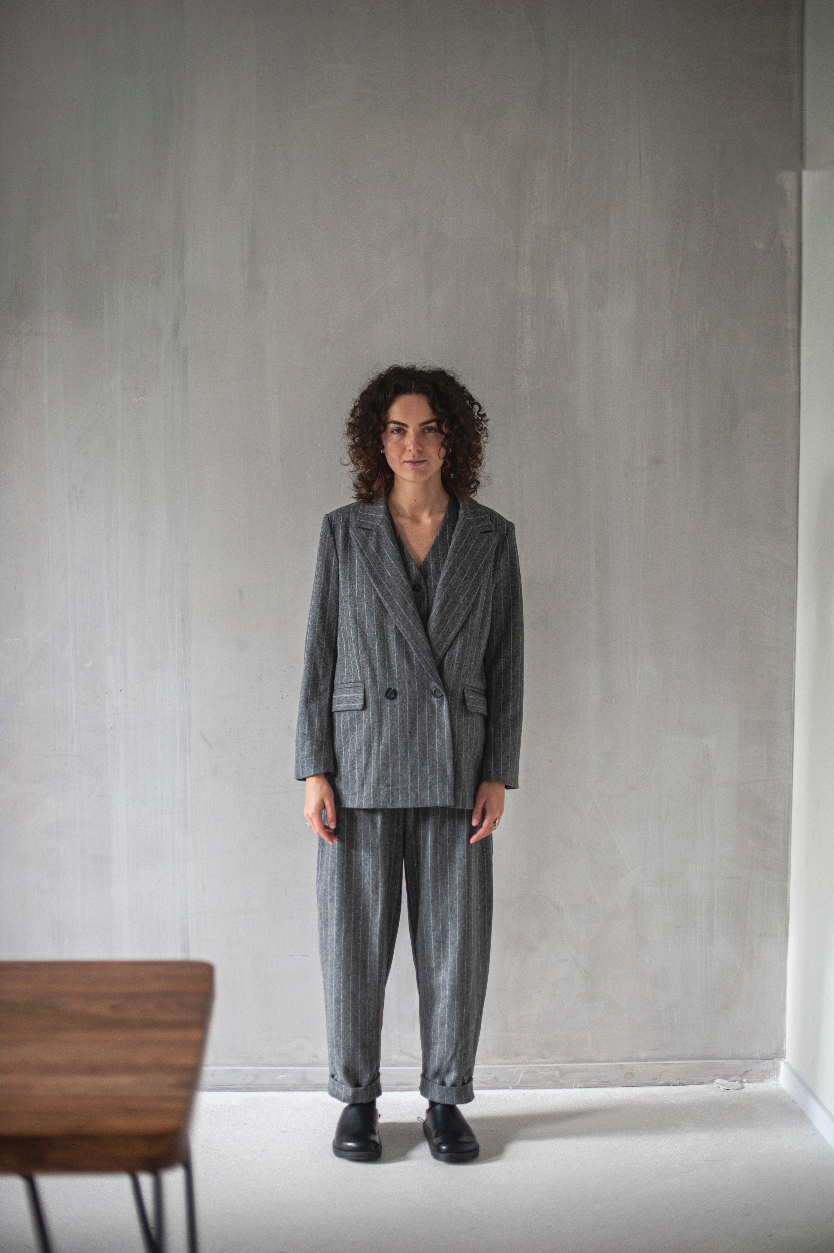 Women's grey striped three-piece pants suit.