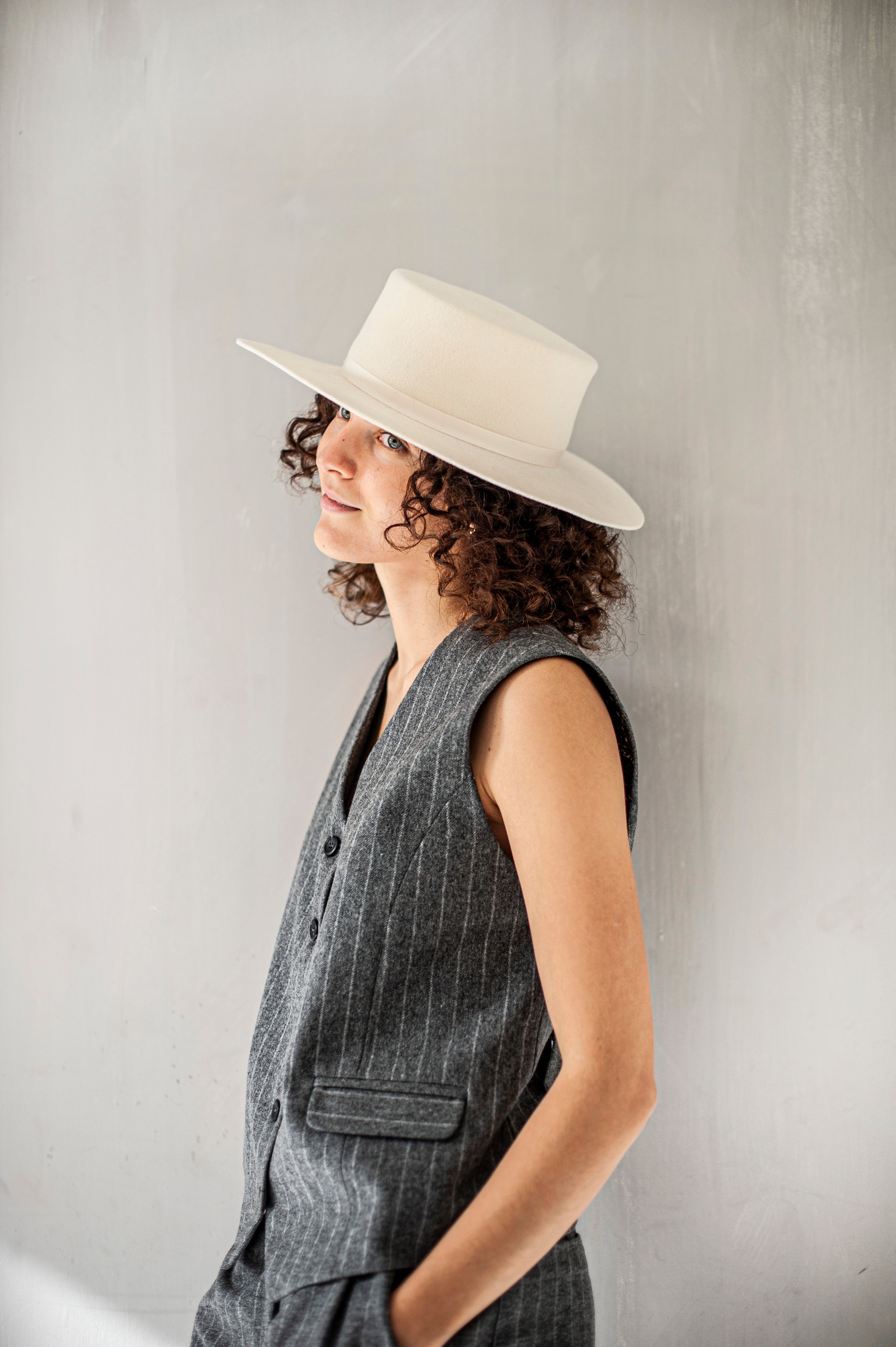 Elegant tweed waistcoat in grey fabric with slim light grey stripes.