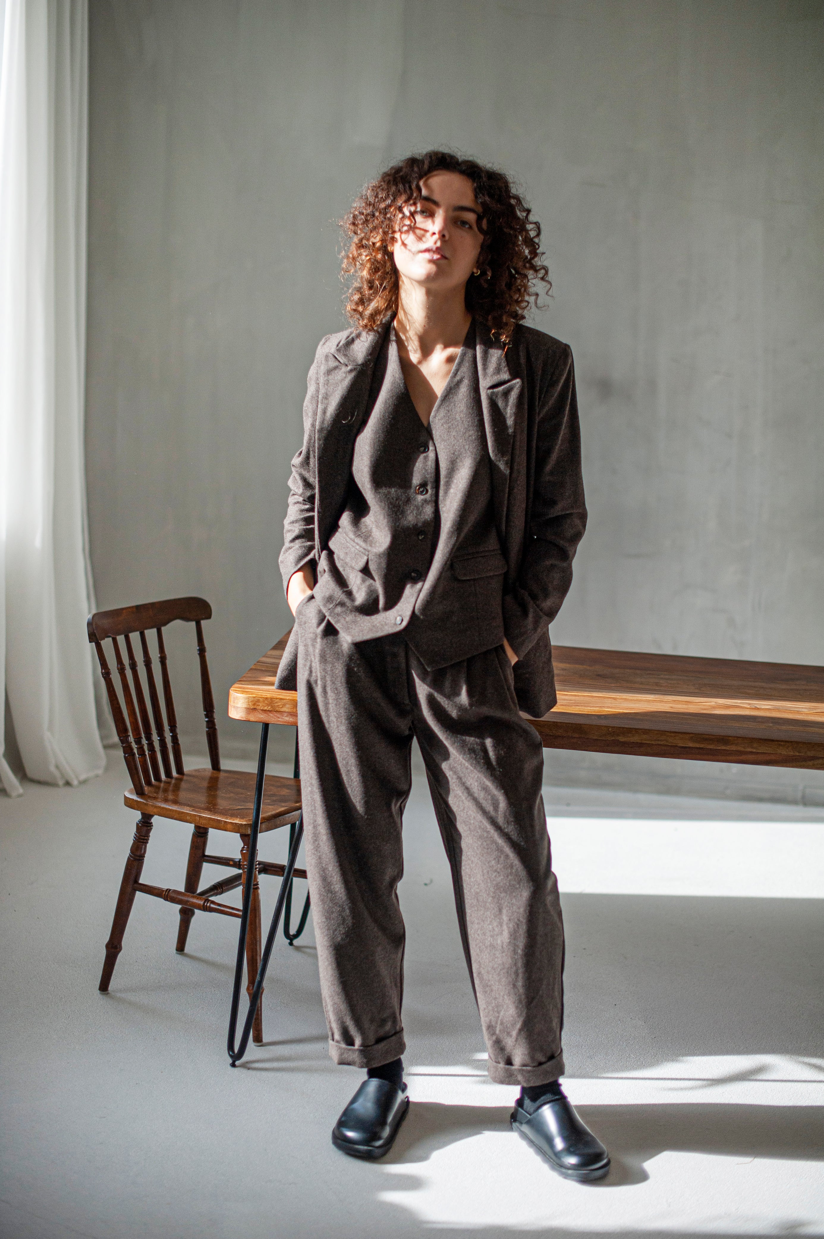 Brown wool tweed blazer with a matching suit vest and loose-fitting tapered trousers with front pleats